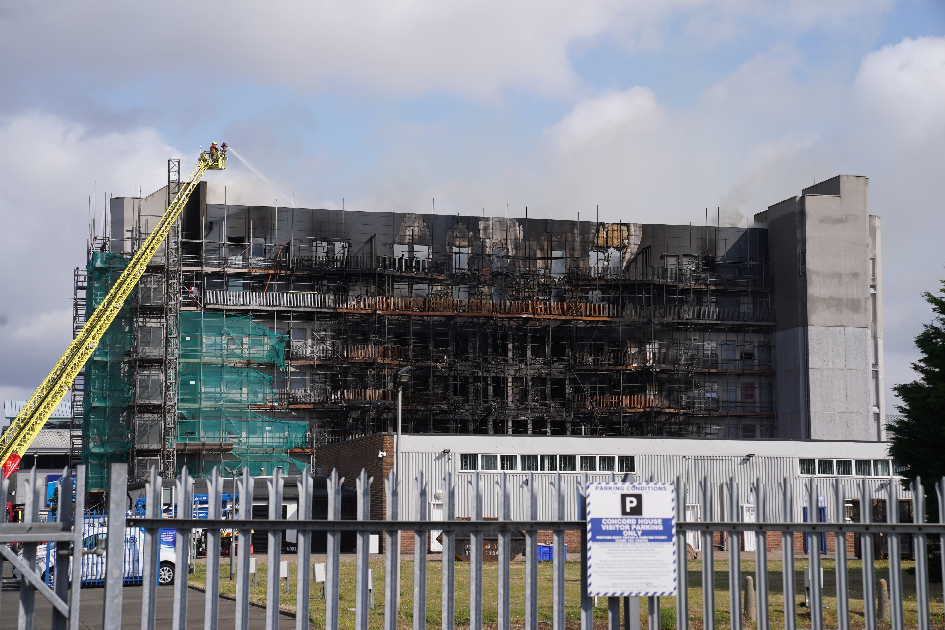 Firefighters at the scene after a blaze at a block of flats on Freshwater Road, Dagenham, east London