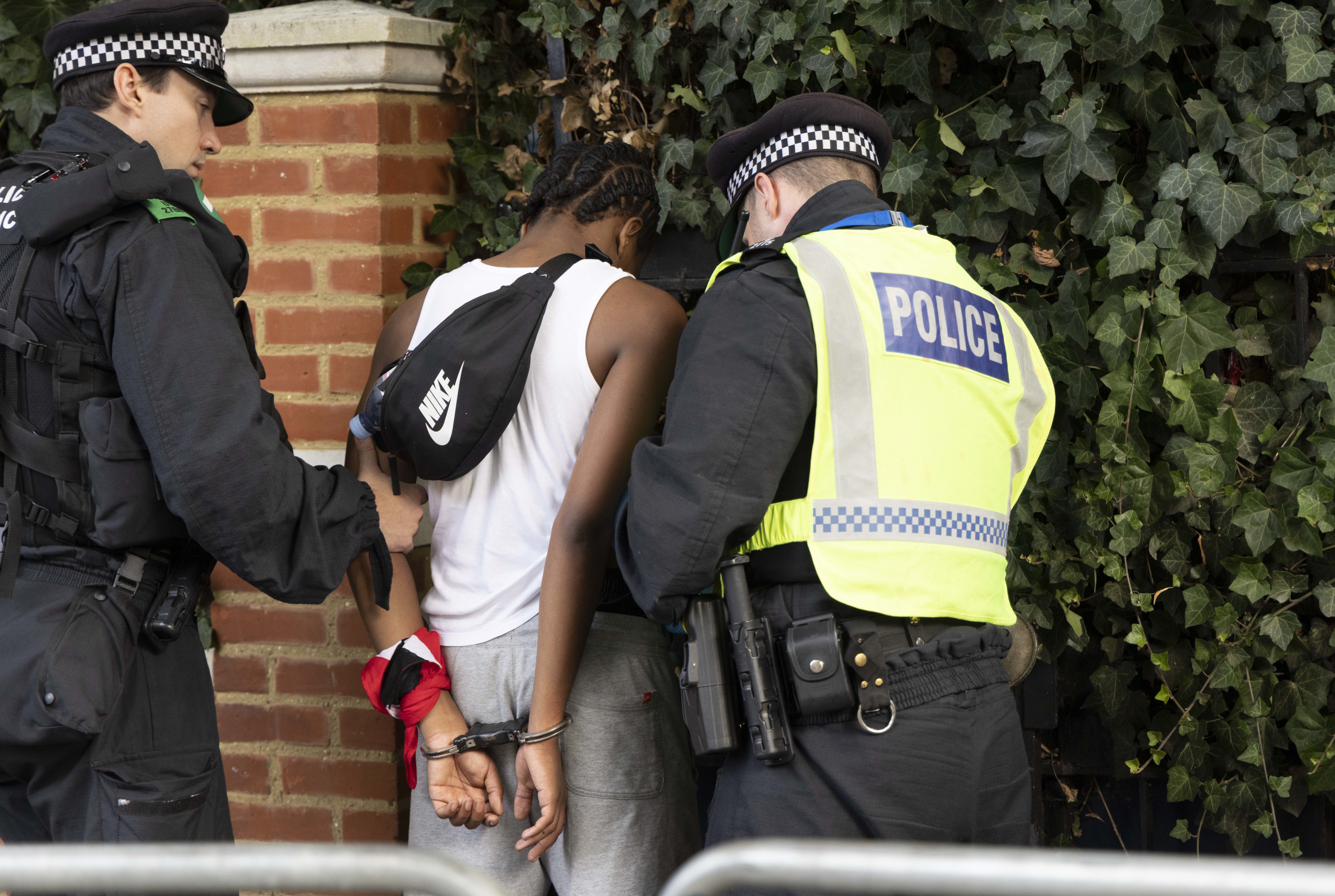 Police detain a man during the Notting Hill Carnival