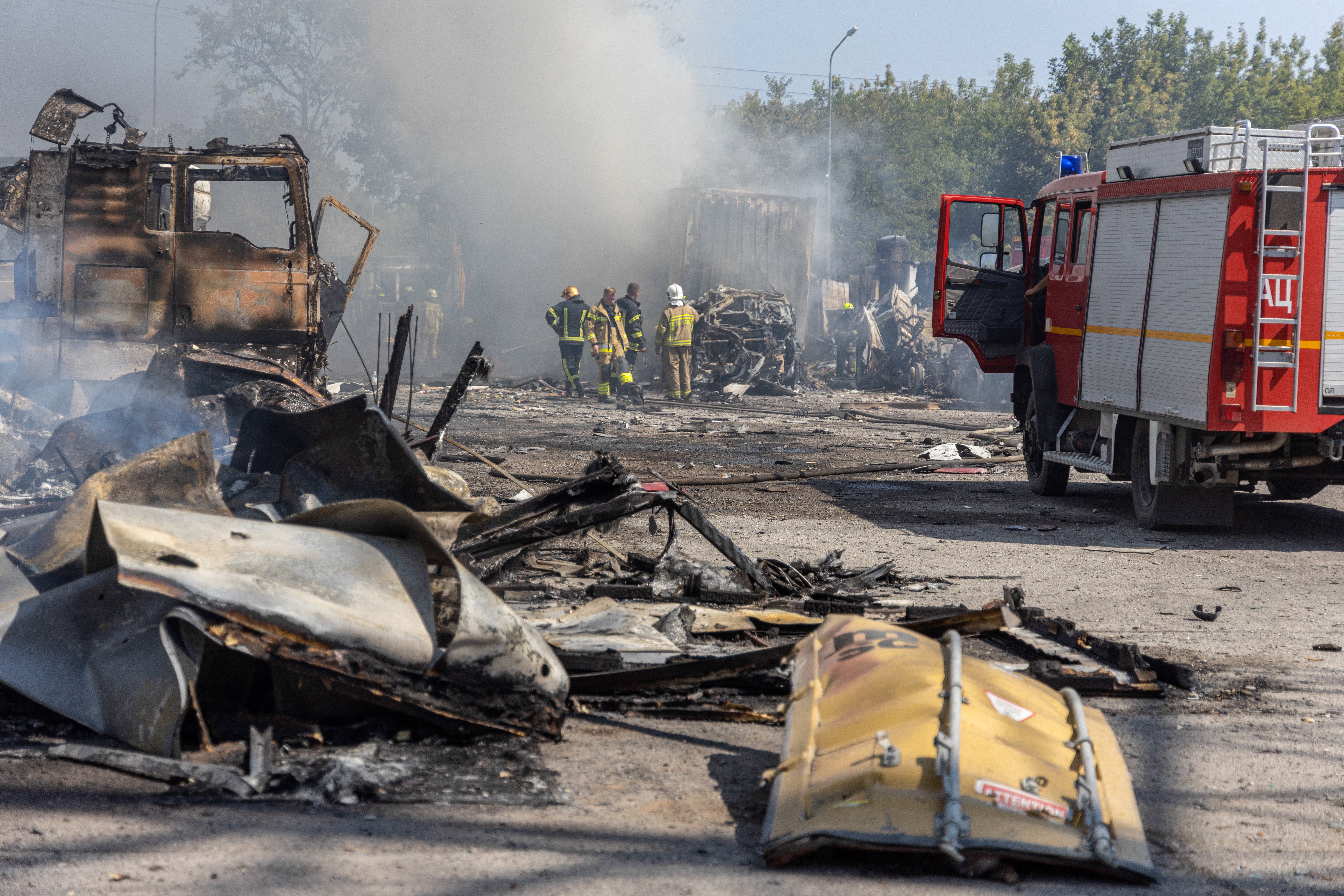 Ukrainian firefighters extinguish a fire on a site following an air attack, in the Odesa region, on 26 August 2024