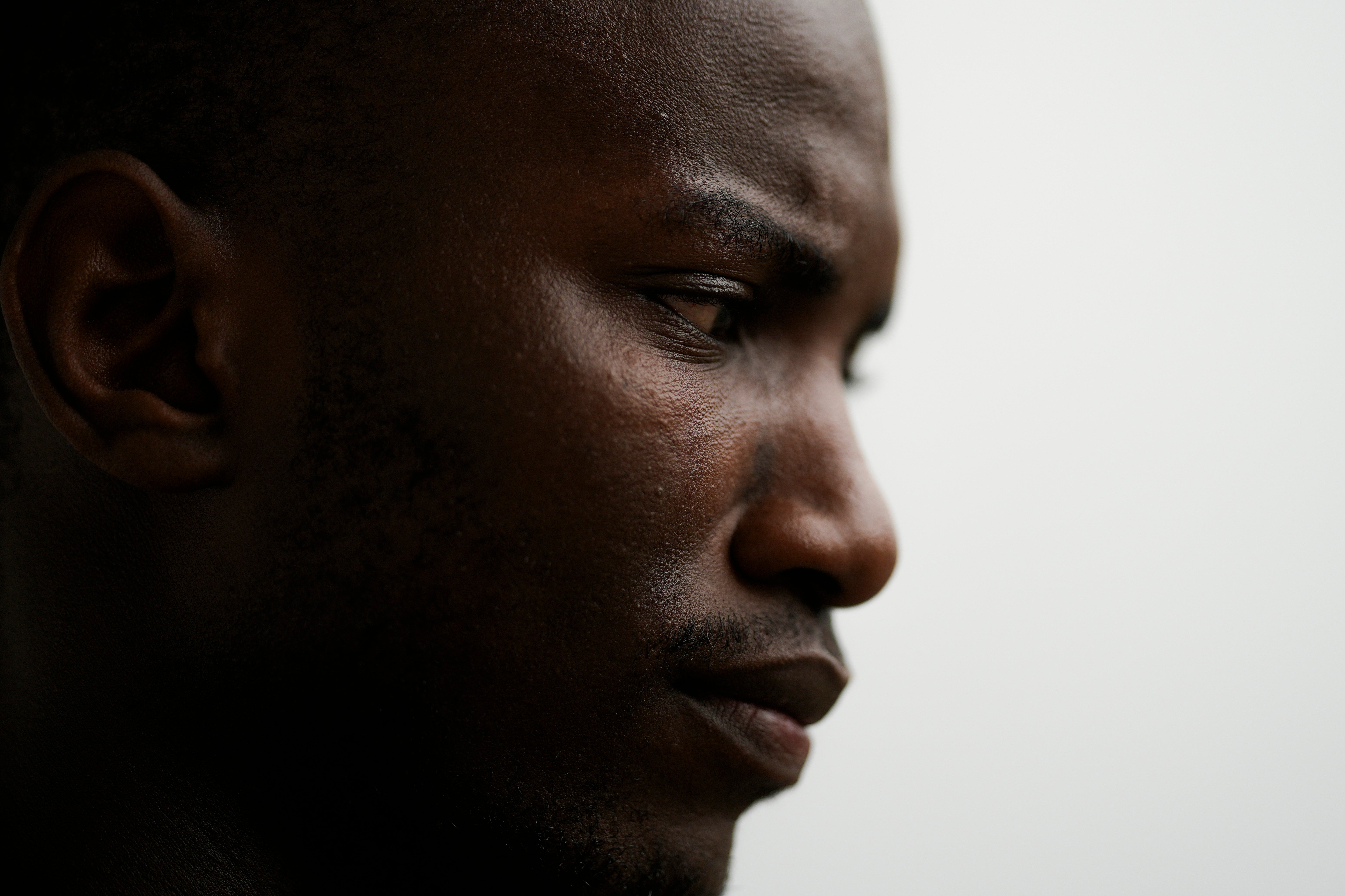 Omar Diallo, a 22-year-old migrant from Guinea in West Africa, poses for a portrait