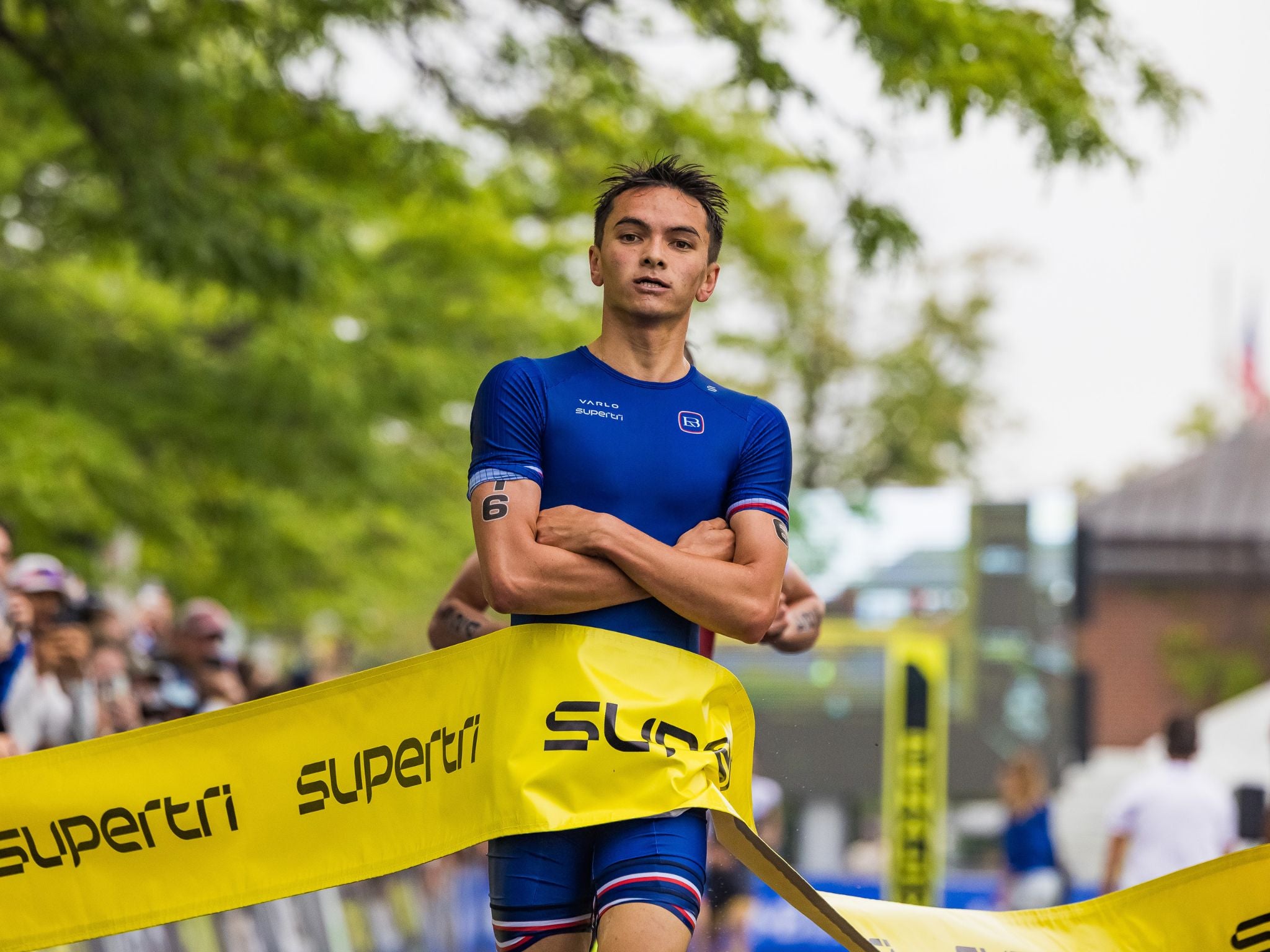 Triathlete Alex Yee crossing the line at the Boston Supertri event