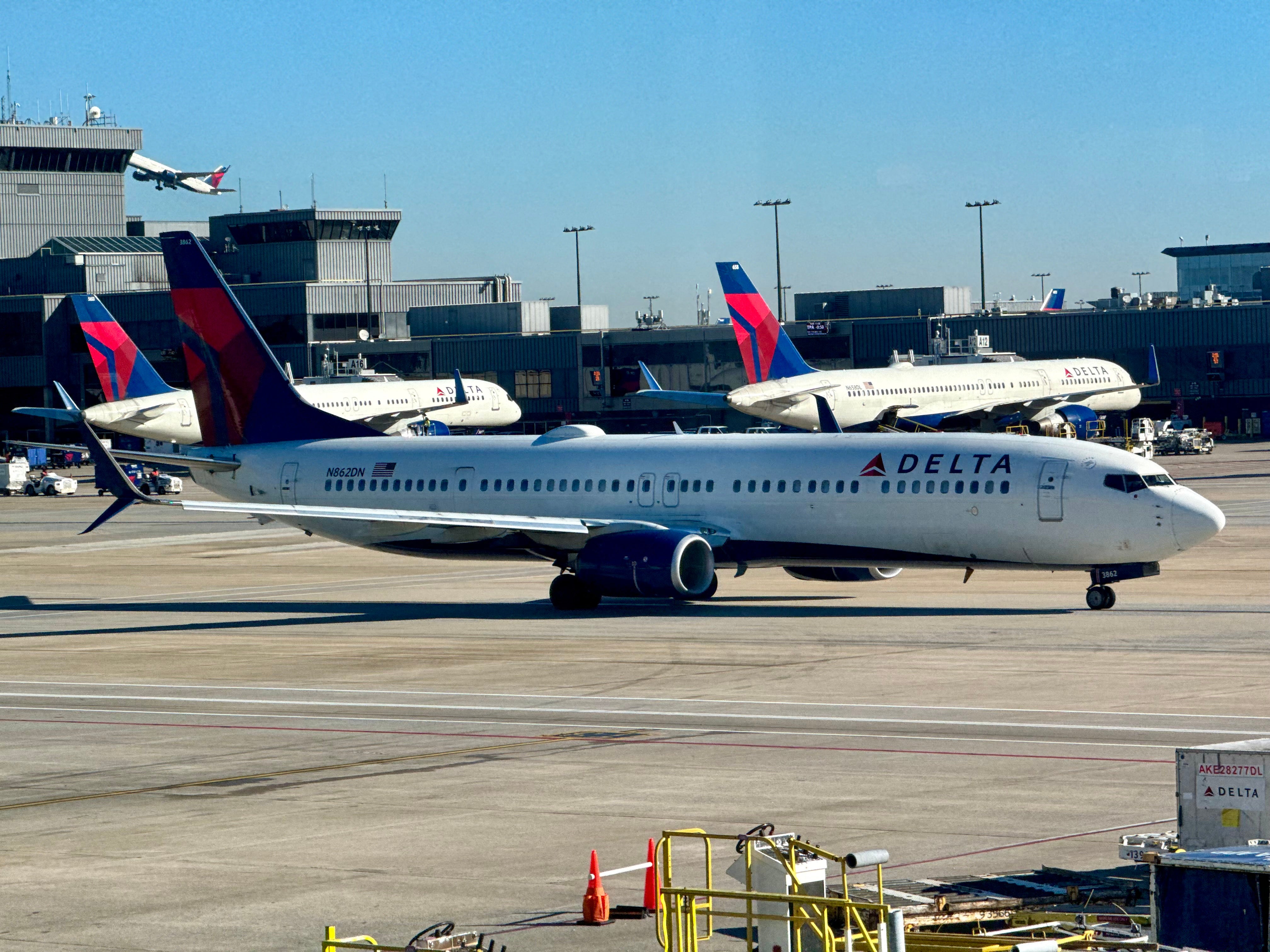 A Delta plane sites at the Hartsfield-Jackson Atlanta International Airport. A tire exploded on a Delta plane sitting in a maintenance area of the airport, killing two Delta employees and injuring a third