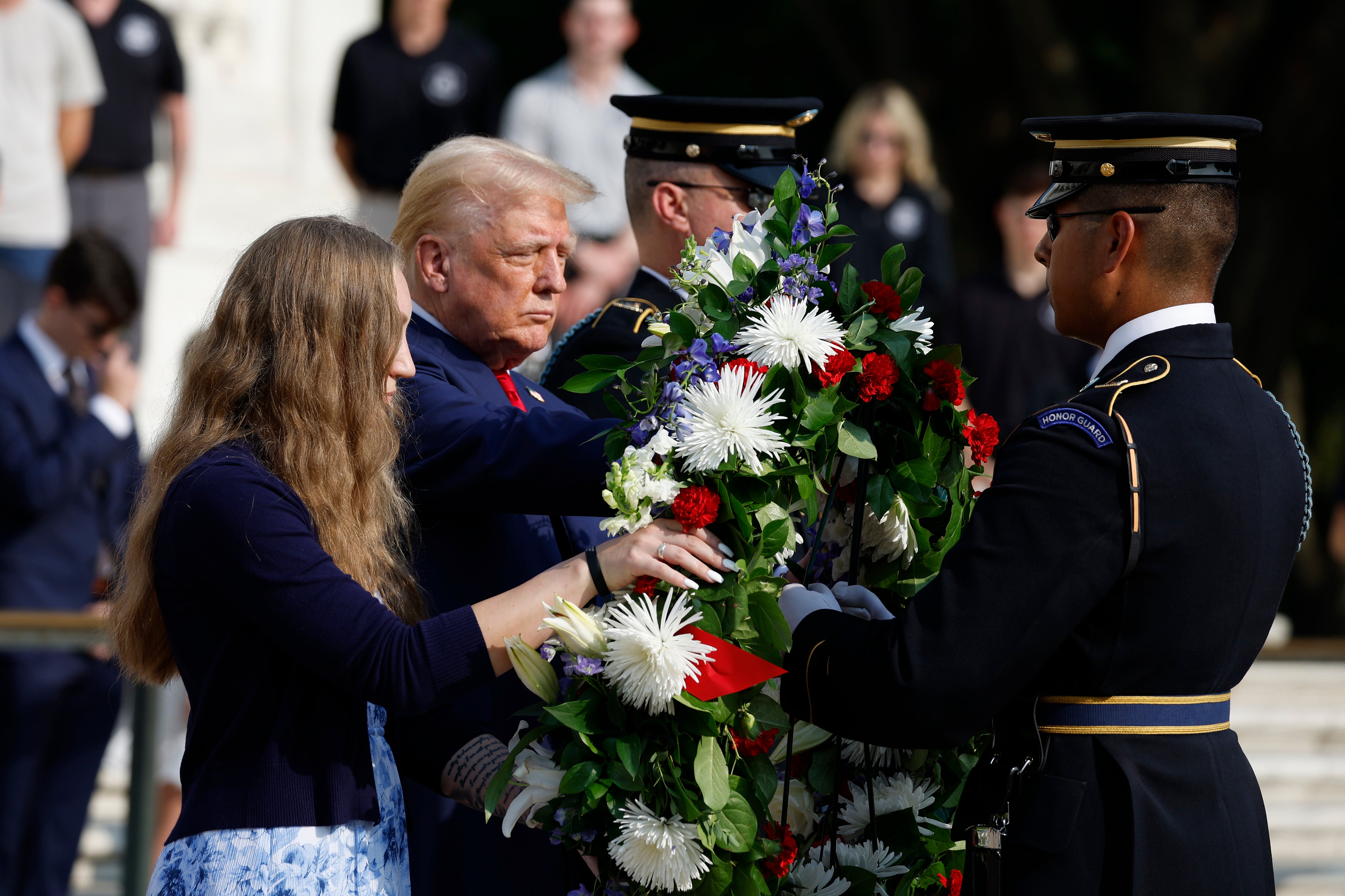 Donald Trump stands alongside Misty Fuoco, whose sister Sgt. Nicole Gee died in Abbey Gate Bombing, at a wreath-laying ceremony at the Tomb of the Unknown Soldier at Arlington National Cemetery on August 26 in Arlington, Virginia