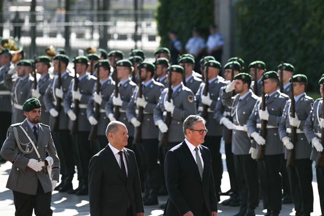 German Chancellor Olaf Scholz and Prime Minister Sir Keir Starmer inspect a military guard of honour (Justin Tallis/PA)