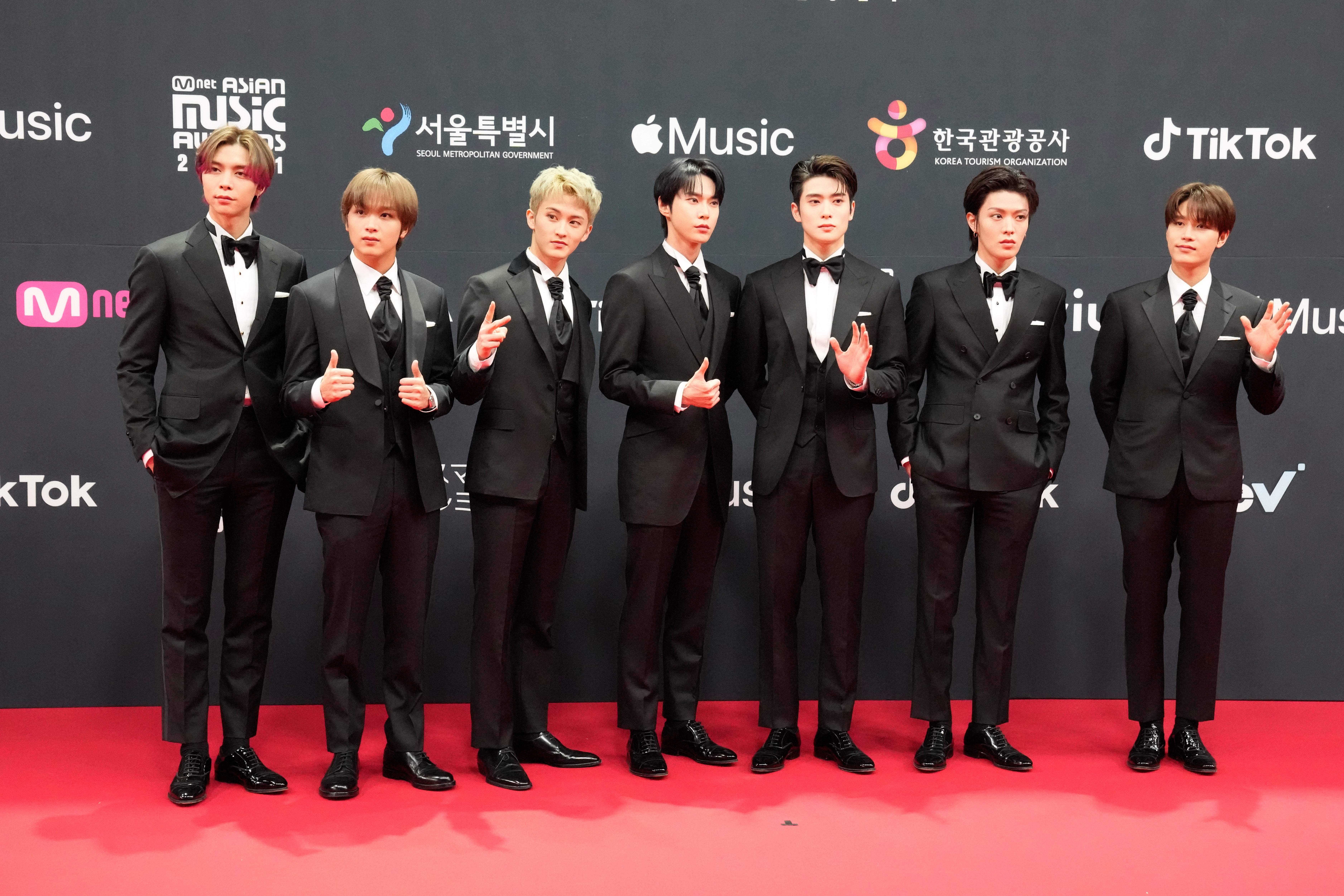 South Korean singer Taeil, right, poses with other members of K-Pop group NCT 127 upon arrival at the 2021 Mnet Asian Music Awards or 2021 MAMA in Paju, South Korea, Saturday, Dec. 11, 2021.