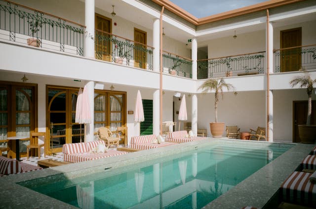 <p>The 18 rooms of the Agora Hotel surround a pool in the courtyard</p>