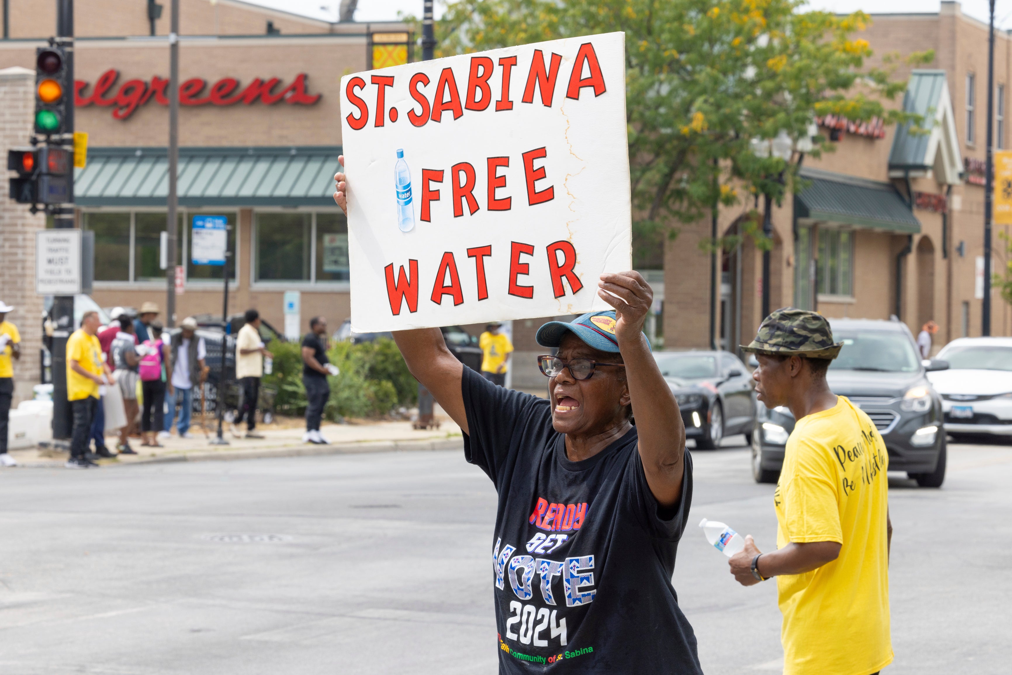 Volunteers from Saint Sabina Church distributed bottles of cold water to passing motorists at a busy South Side intersection in Chicago, Aug. 27, 2024