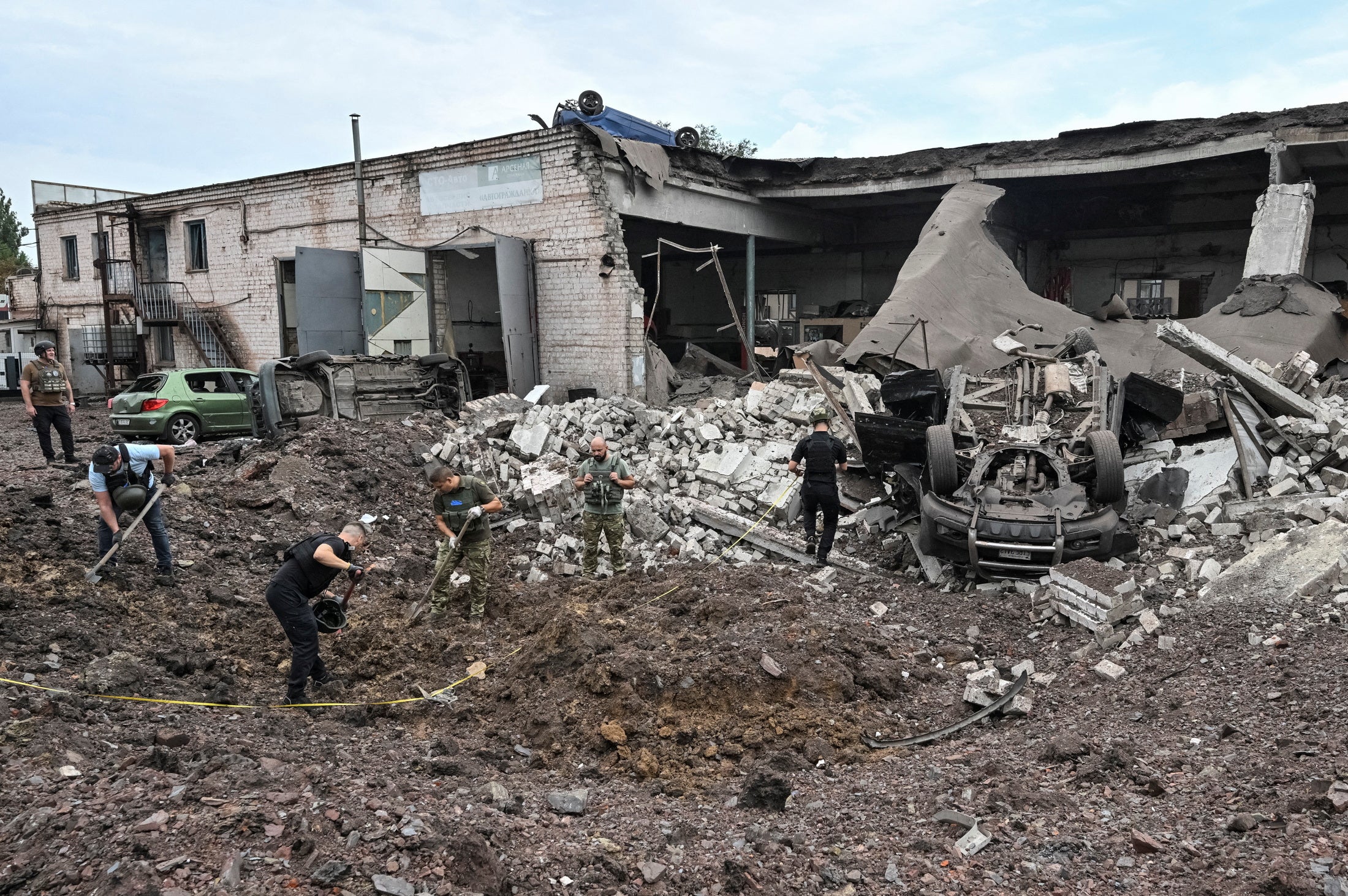 Police experts work at a site of a Russian missile strike, amid Russia's attack on Ukraine in Kryvyi Rih