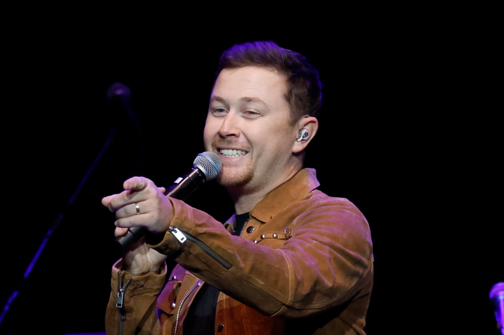 Scotty McCreery performing onstage in 2023