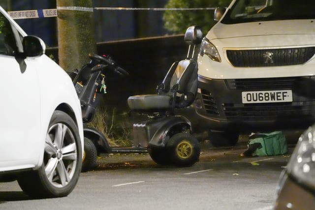 <p>A black and grey electric wheelchair could be seen standing behind the cordon close to a forensics tent at the scene late on Wednesday evening</p>