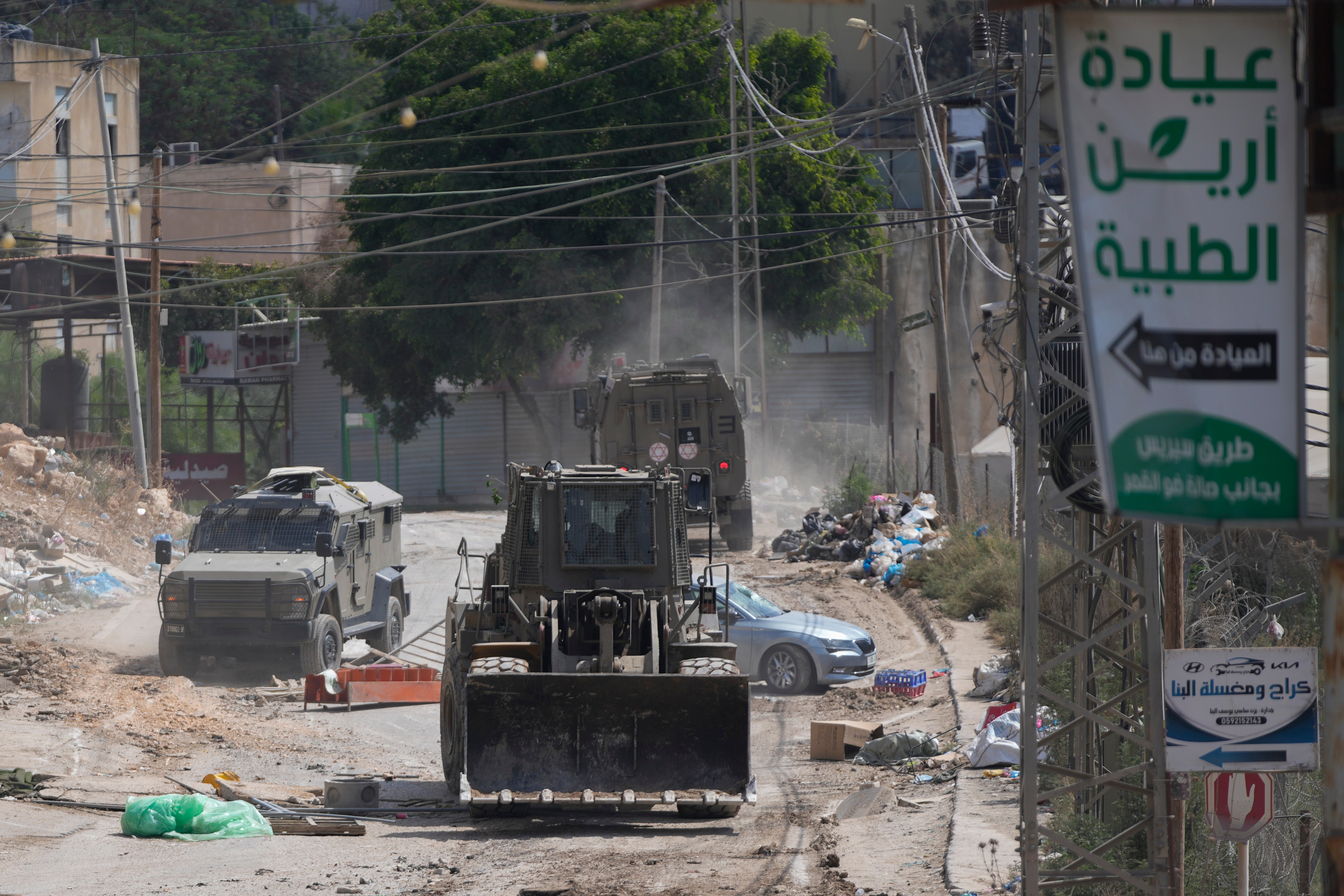 A bulldozer from the Israeli forces moves on a street during a military operation in the West Bank