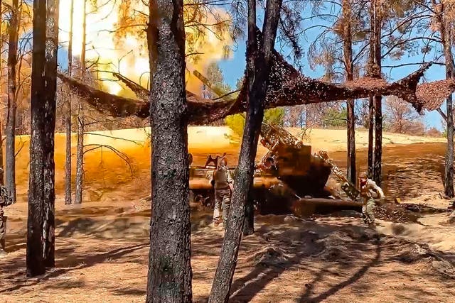 <p>Russian soldiers fire a 203mm self-propelled gun towards Ukrainian positions from an undisclosed location in Ukraine</p>