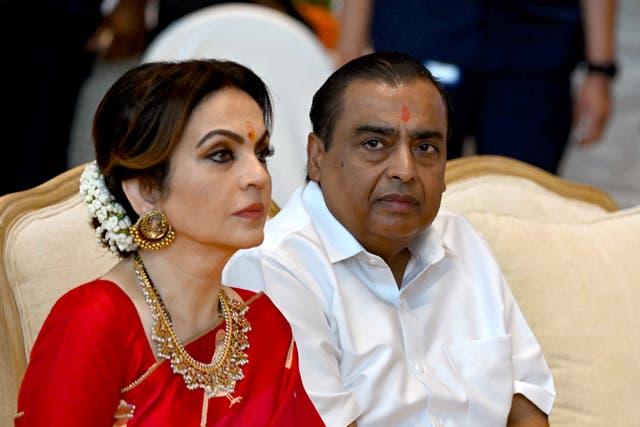 <p>File. Billionaire tycoon and chairman of Reliance Industries Mukesh Ambani (R) with his wife Nita Ambani, who will reportedly oversee the merger between Disney and Reliance </p>