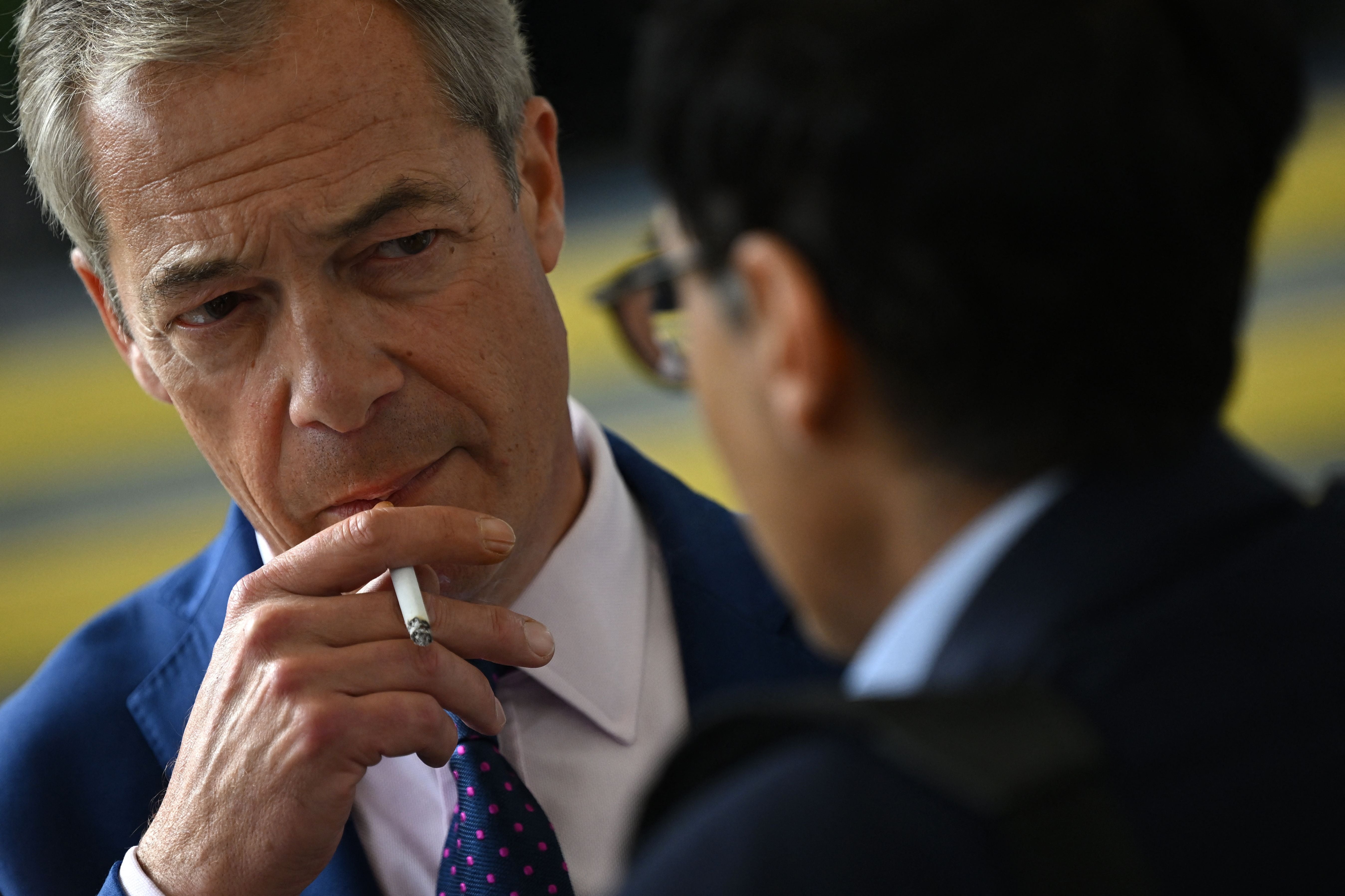 Nigel Farage enjoys a cigarette, 2023