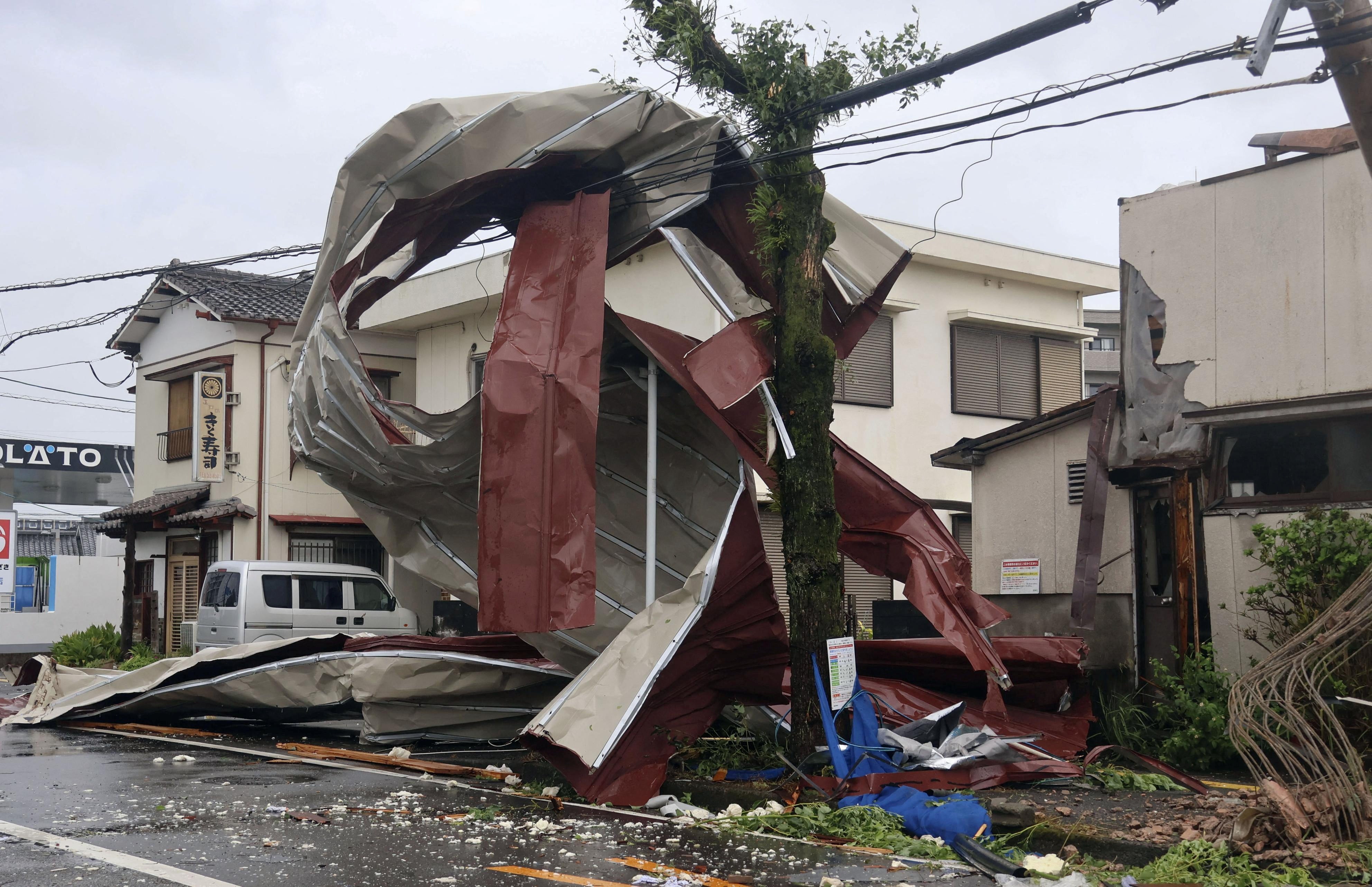 An object blown by strong winds caused by Typhoon Shanshan is stranded on a power line in Miyazaki