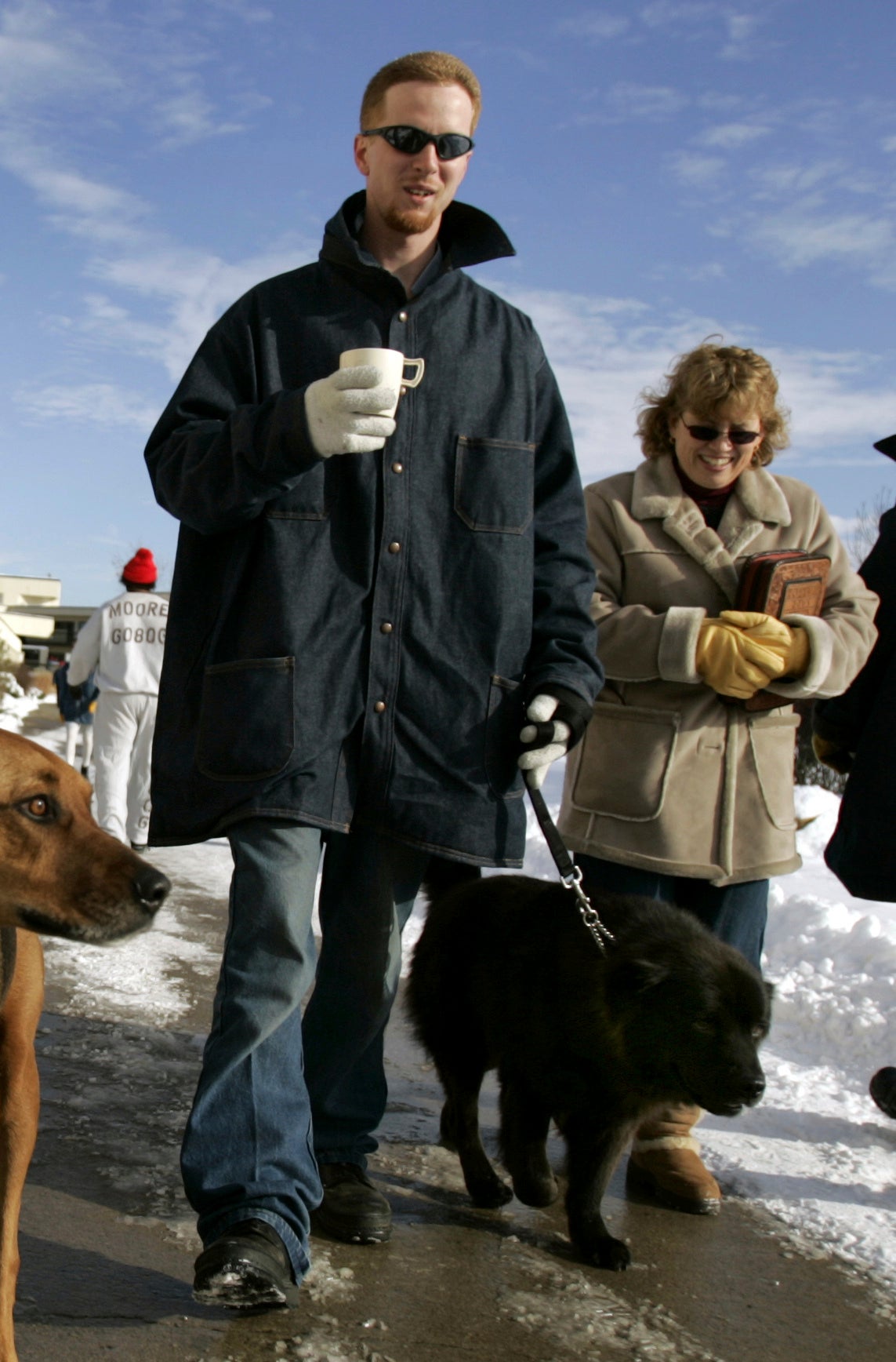 John Manard, left, walking a dog with Toby Dorr, then Young in December 2005