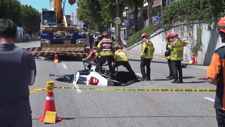 <p>Sinkhole swallows couple’s car in Seoul.</p>