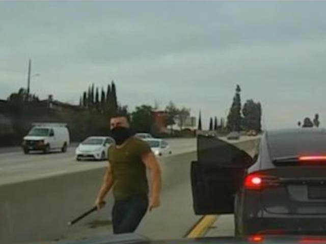 <p>Nathaniel Radimak of Los Angeles approaches a truck with a pipe in his hand after exiting his Tesla. Radimak beat a truck with the pipe in one of many 2022 road rage incidents that resulted in his arrest. He pleaded guilty and was sentenced to five years in prison in 2023, but was paroled after 10 months</p>