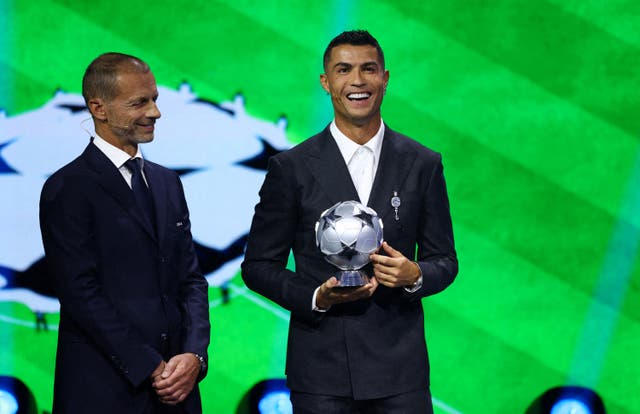 <p>Aleksander Ceferin, left, and Cristiano Ronaldo </p>