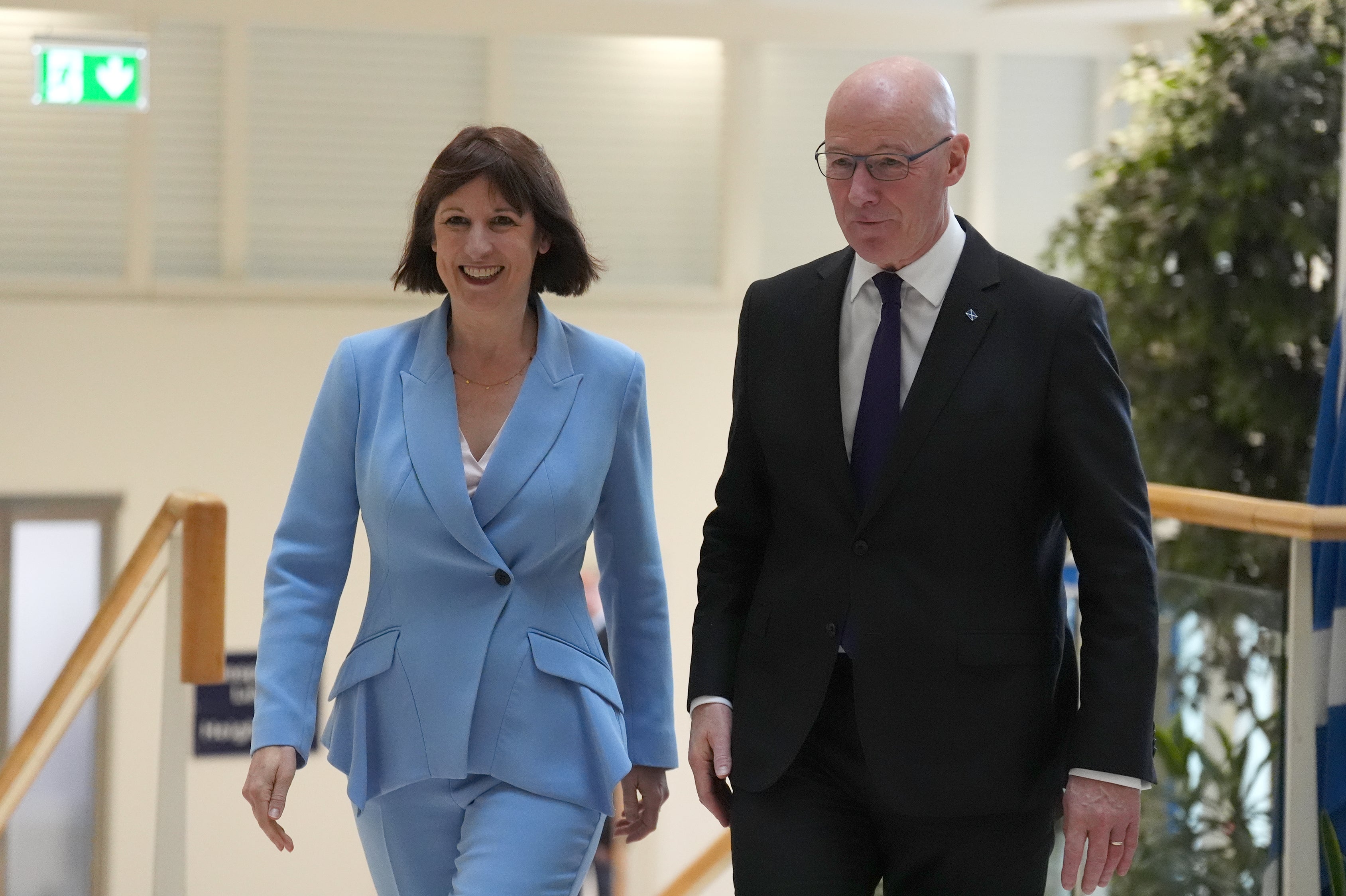 Chancellor Rachel Reeves, left, with first minister John Swinney, right