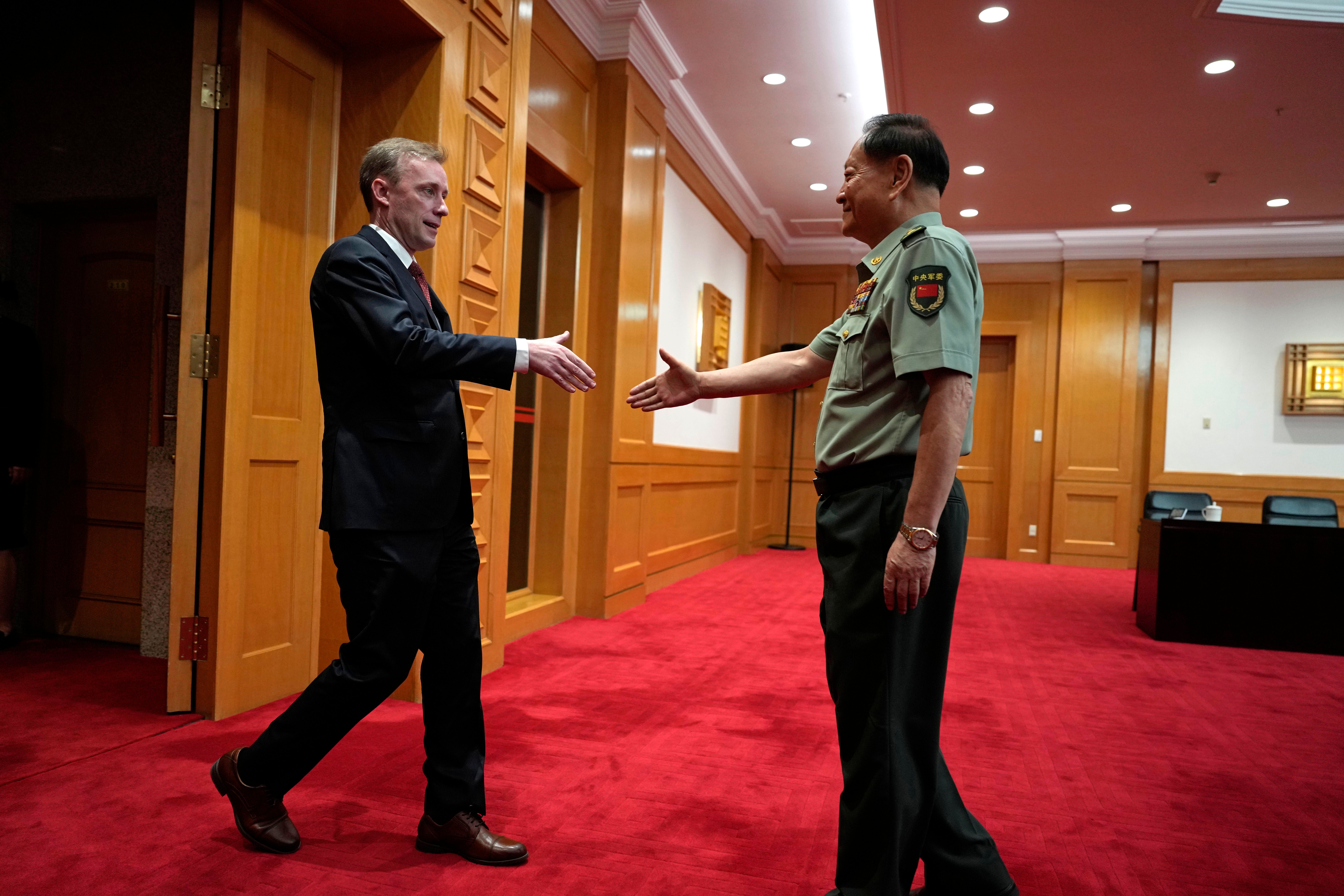 Zhang Youxia, vice chairman of the CPC Central Military Commission, right, shakes hands with White House national security adviser Jake Sullivan before a meeting at the Bayi building in Beijing