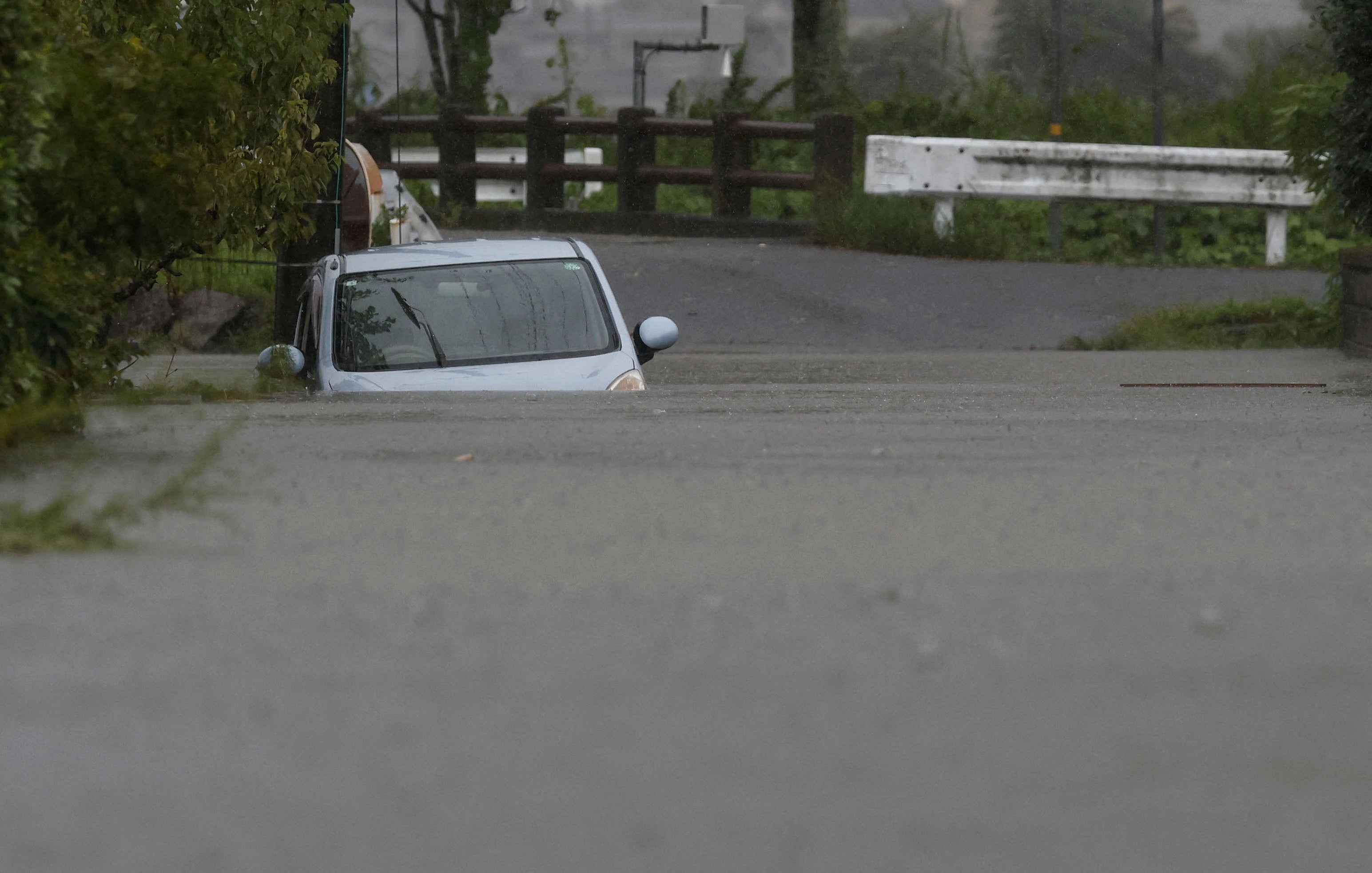 A car is submerged at a flooded area due to heavy rains from Typhoon Shanshan in Yufu, Oita Prefecture, southwestern Japan