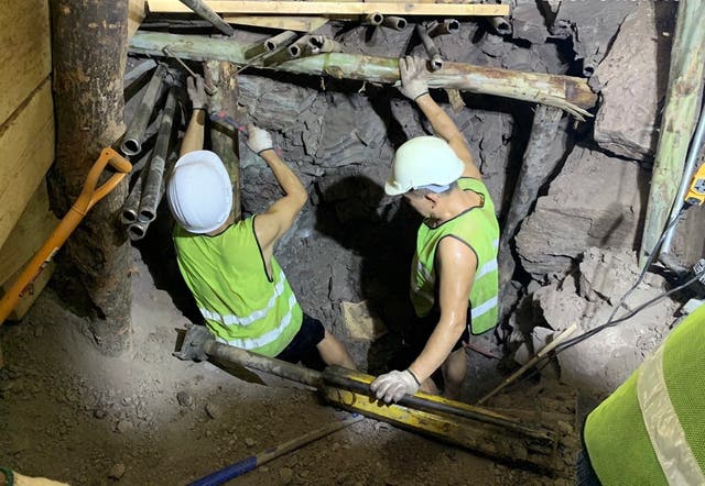 <p>Rescuers working to save three trapped workers trapped in a tunnel collapse</p>