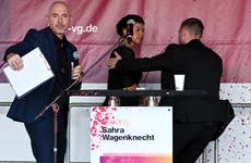 Prominent German leftist politician sprayed with a red liquid, likely paint, during campaign event