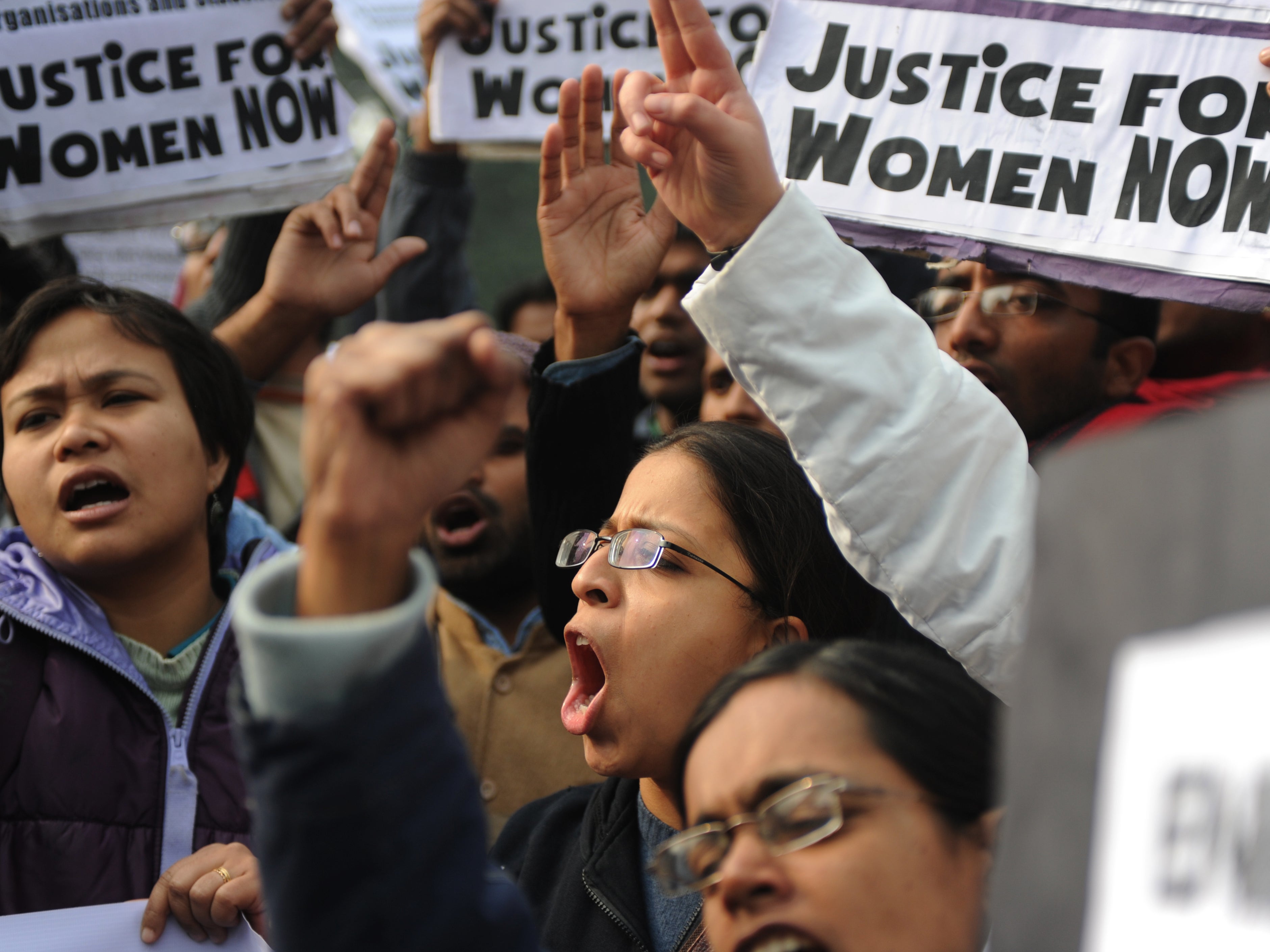 File. Indian demonstrators shout slogans and wave placards during a protest calling for better safety for women