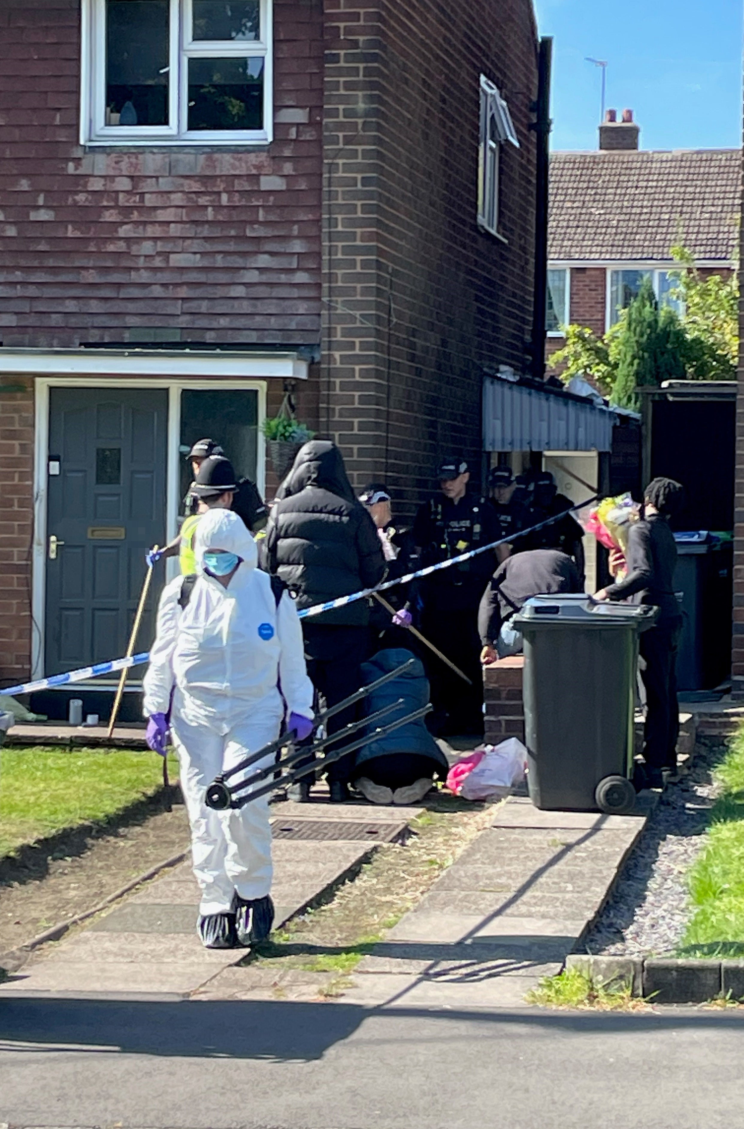 Police and forensic officers at the scene in Lovett Avenue, Oldbury