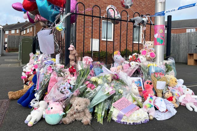 Floral tributes are left at the entrance to Robin Close, Rowley Regis after the death of Shay Kang (Matthew Cooper/PA)