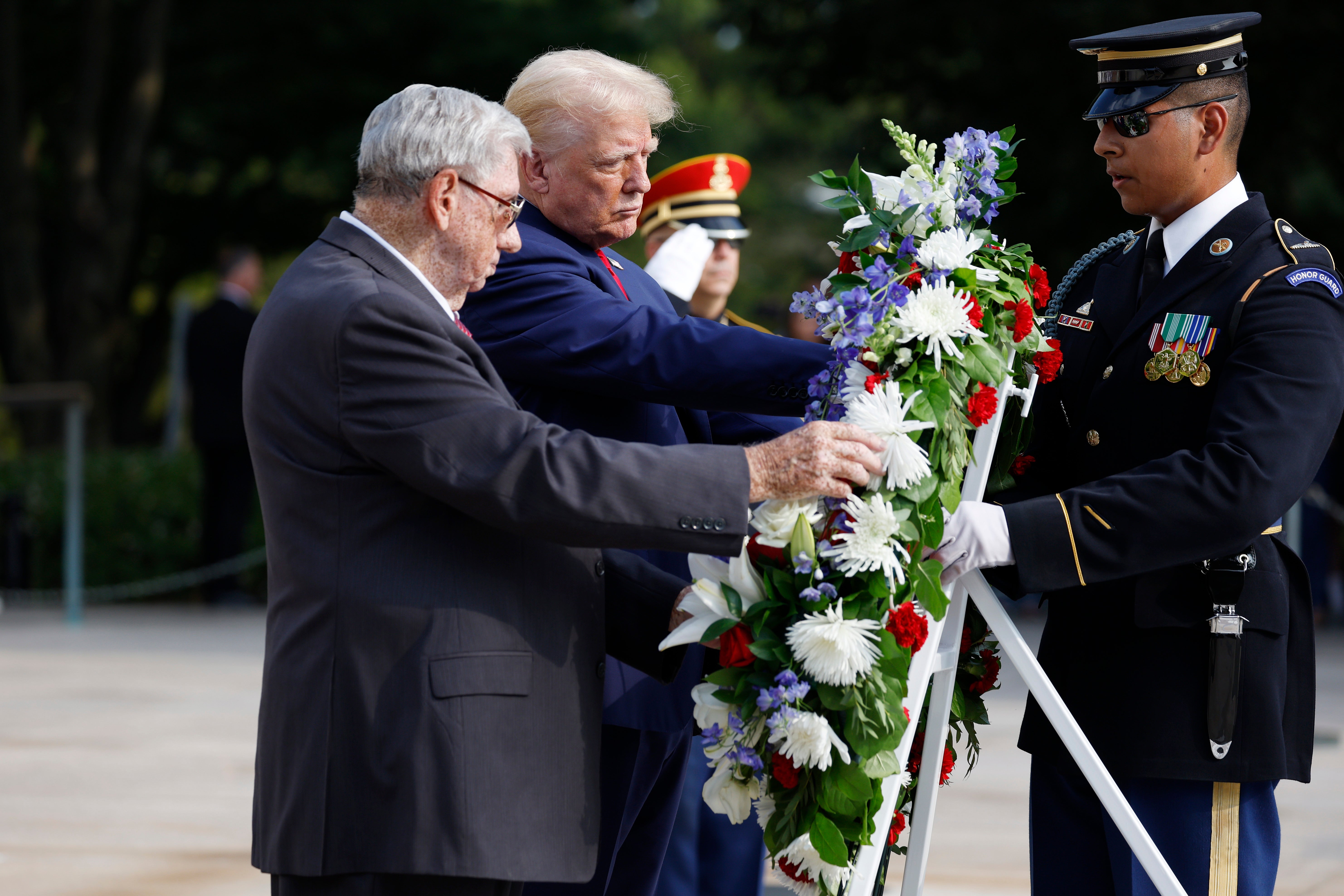 Donald Trump stands alongside Bill Barnett (L), who’s grandson Staff Sgt Darin Taylor Hoover died in Abbey Gate Bombing, during a wreath laying ceremony at the Tomb of the Unknown Soldier at Arlington National Cemetery on August 26. Trump’s campaign aide has doubled down on his dispute with the cemetery, calling the US Army ‘hacks’