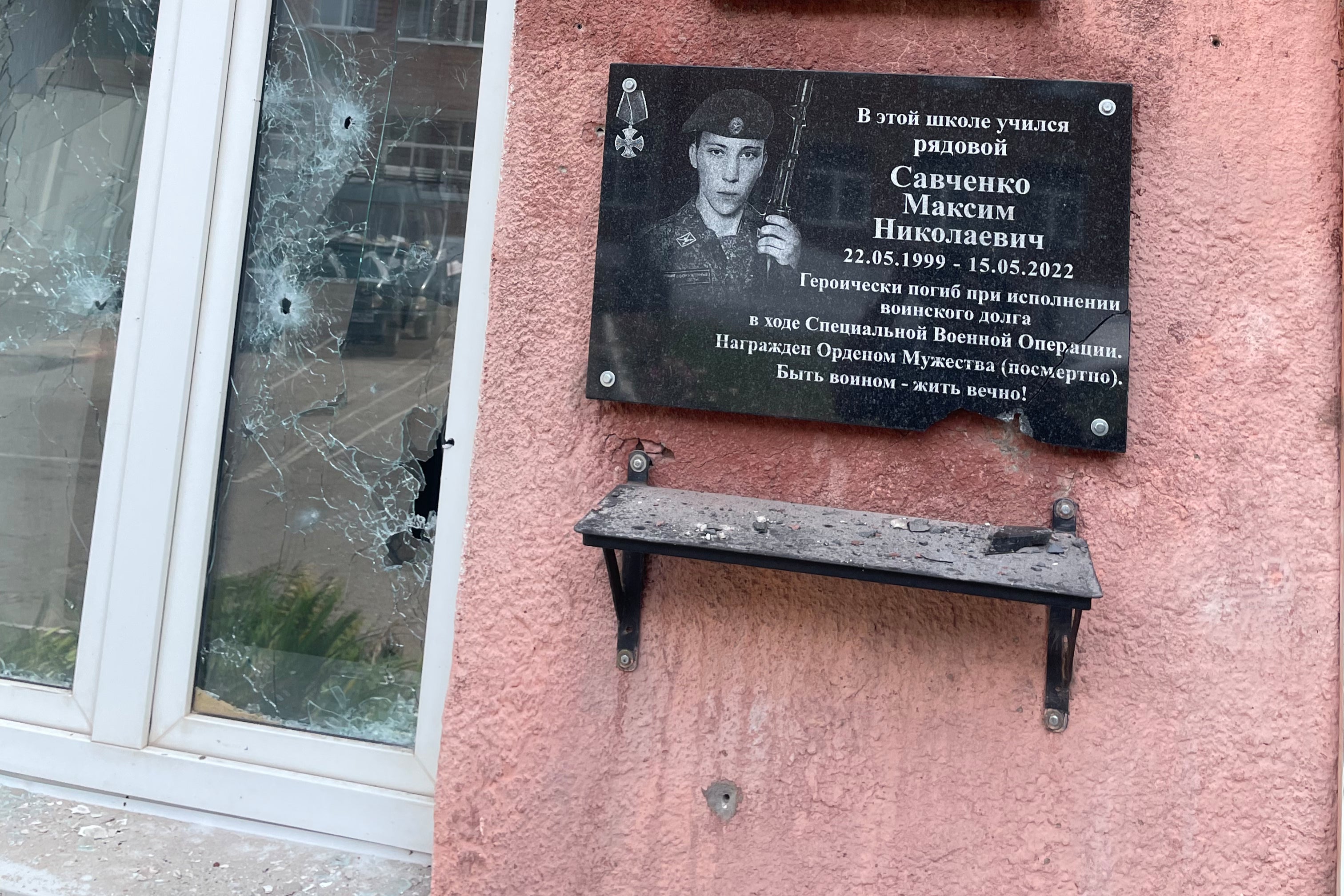 A damaged local administration office in the Kursk region – with a plaque to a Russian soldier killed in Ukraine