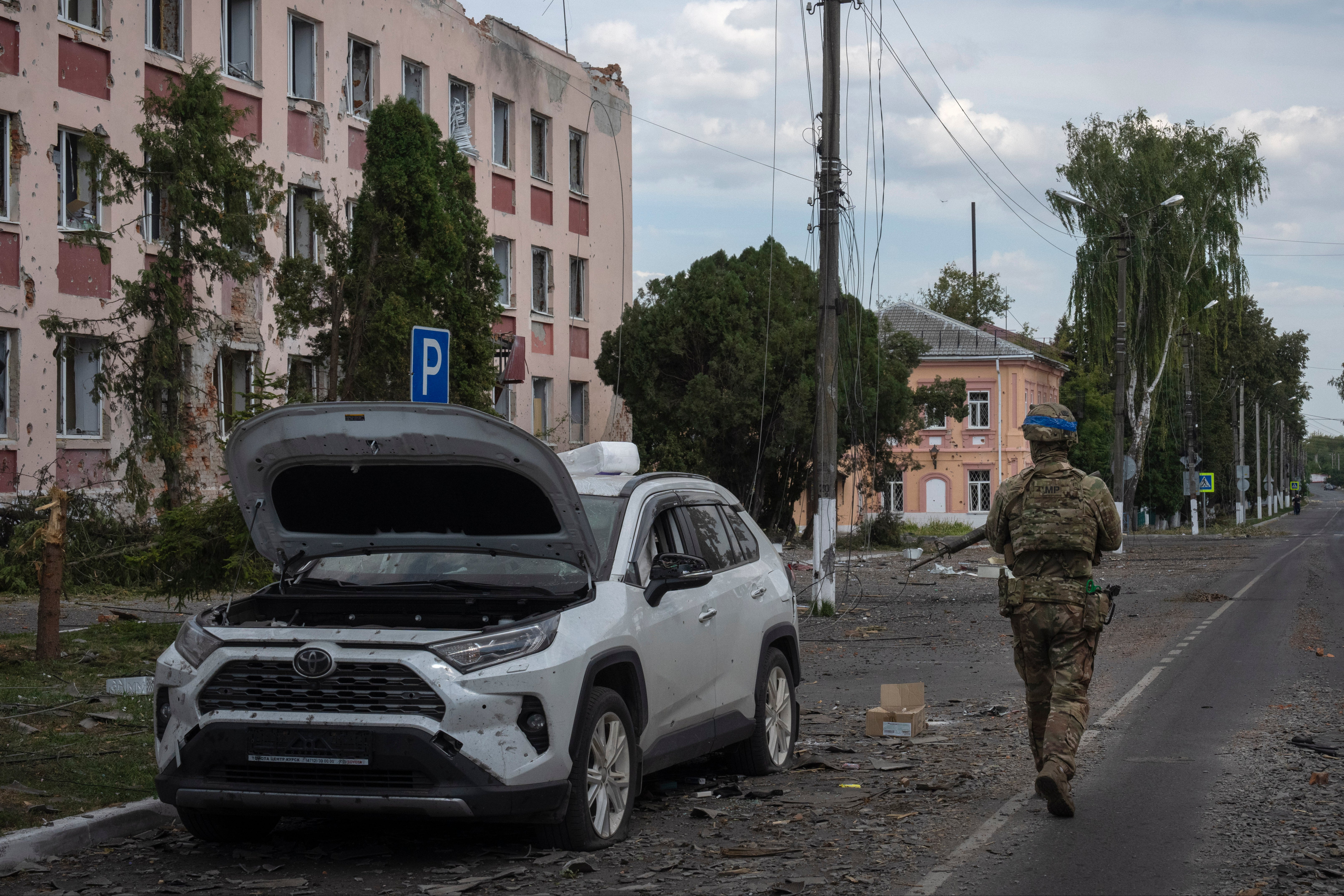 A Ukrainian soldier walks past a city hall in Sudzha in the Kursk region of Russia in August after Ukraine sent its forces to the region in recent weeks