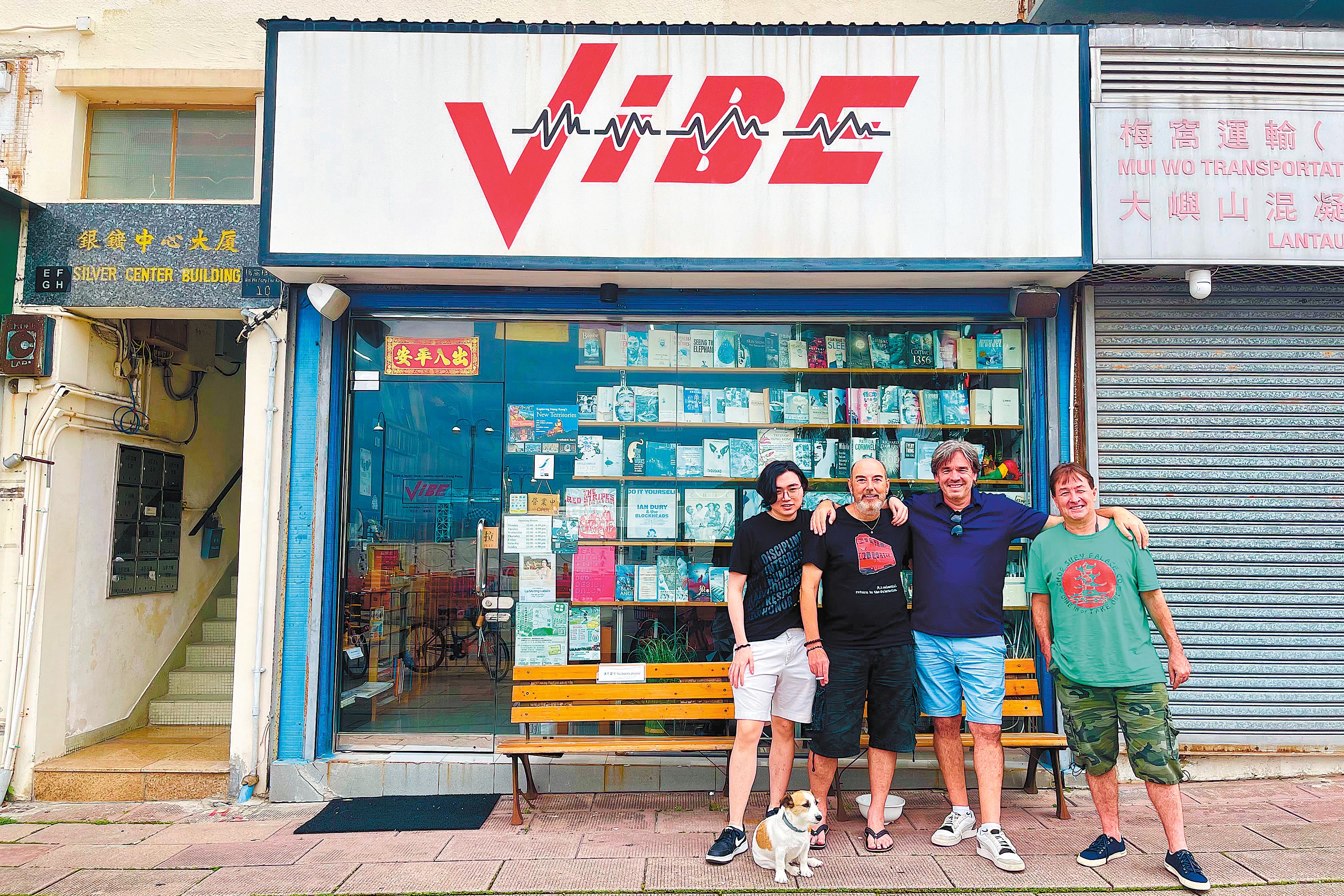 Gary Brightman (second left), owner of vintage music and book store Vibe, with his friends outside the store in the Silvermine Bay area of Mui Wo, Lantau Island in Hong Kong in June