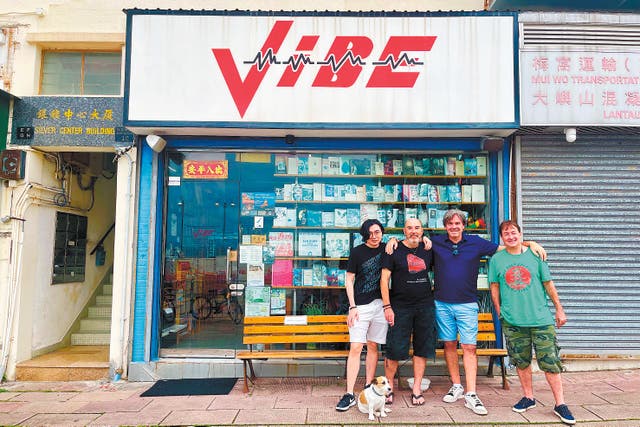 <p>Gary Brightman (second left), owner of vintage music and book store Vibe, with his friends outside the store in the Silvermine Bay area of Mui Wo, Lantau Island in Hong Kong in June </p>