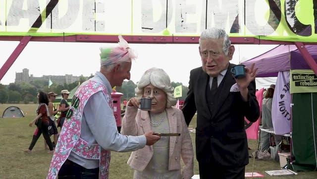 <p>Climate protesters wearing Charles and Camilla masks join demonstration in Windsor.</p>