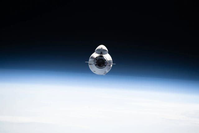 <p>The SpaceX Dragon cargo spacecraft is seen from the International Space Station. NASA astronaut Nick Hague and Roscosmos cosmonaut Aleksandr Gorbunov will fly to the orbiting laboratory on a Dragon capsule next month and come back with the stranded Boeing Starliner astronauts in 2025 </p>