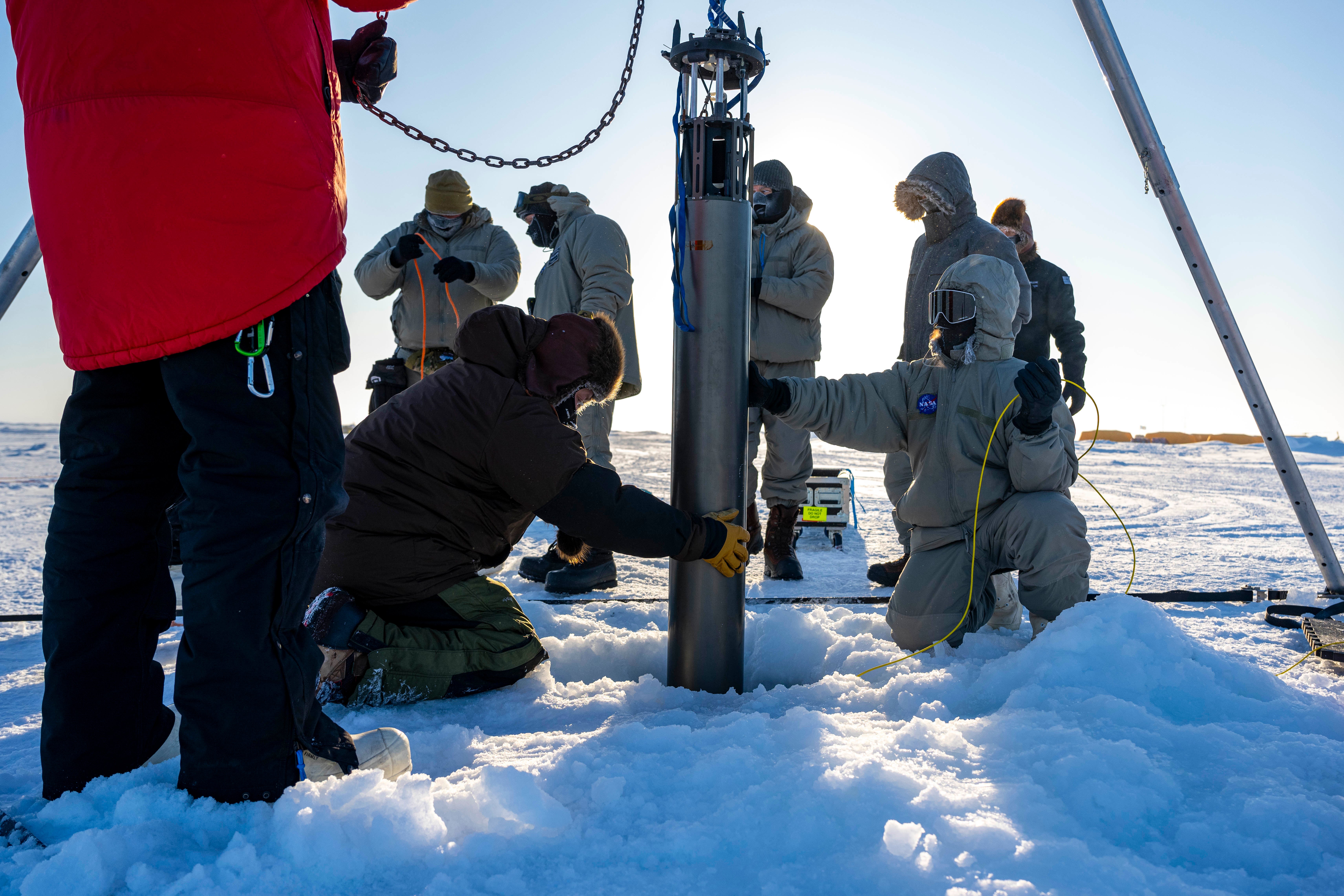 Nasa researchers work on a field test of the autonomous IceNode robot north of Alaska in March. Scientists at the agency’s Jet Propulsion Laboratory are hoping to develop a fleet of these robots some day, to help better understand ice shelf melt rates.