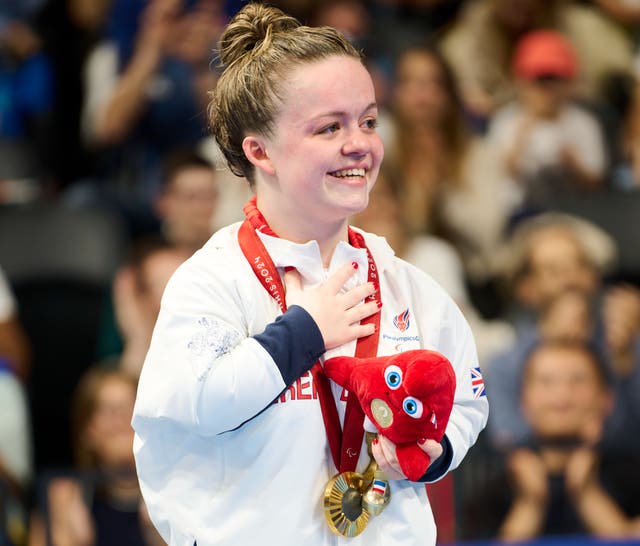 <p>Maisie Summers-Newton celebrates her gold medal </p>