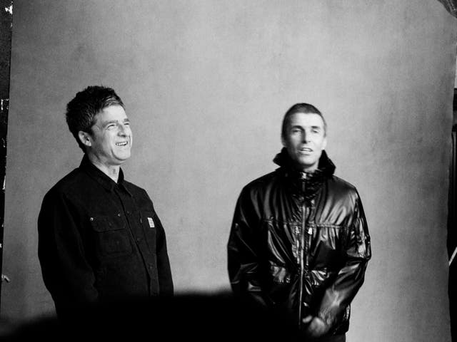 <p>Noel and Liam smile as they’re photographed as part of the Oasis reunion</p>