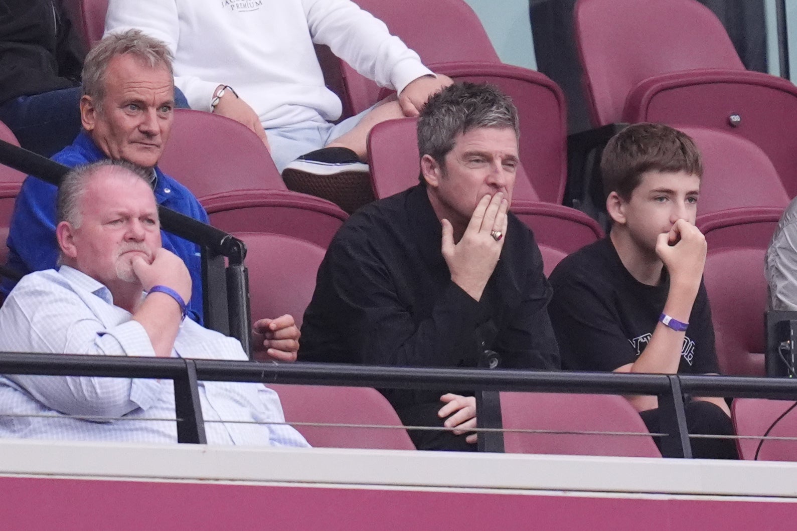 Noel Gallagher (centre) watches from the stands on the day Oasis’ comeback tour tickets went on sale (John Walton/PA)