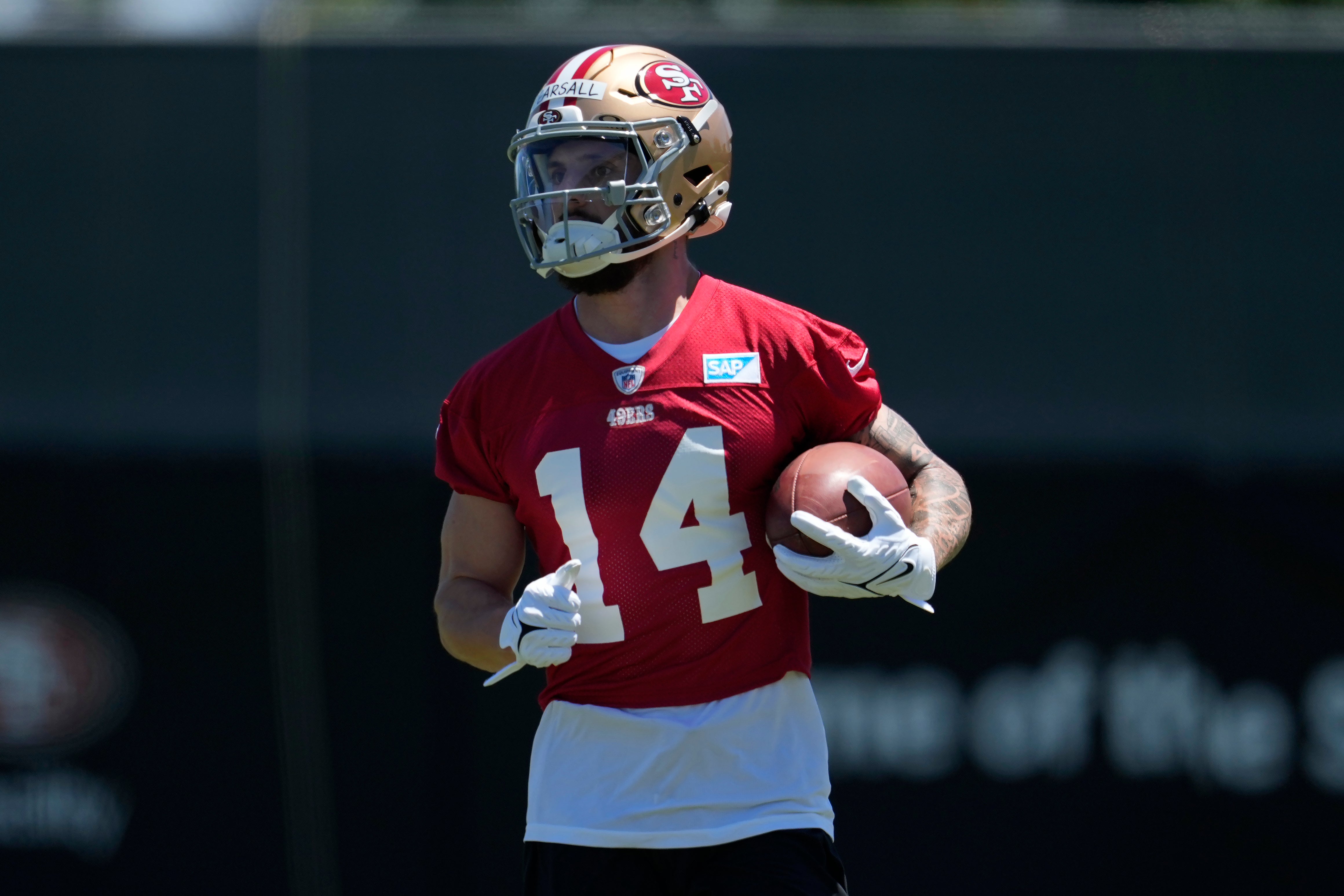 San Francisco 49ers wide receiver Ricky Pearsall carries the ball during the NFL football team’s rookie minicamp in May. He is in serious but stable condition