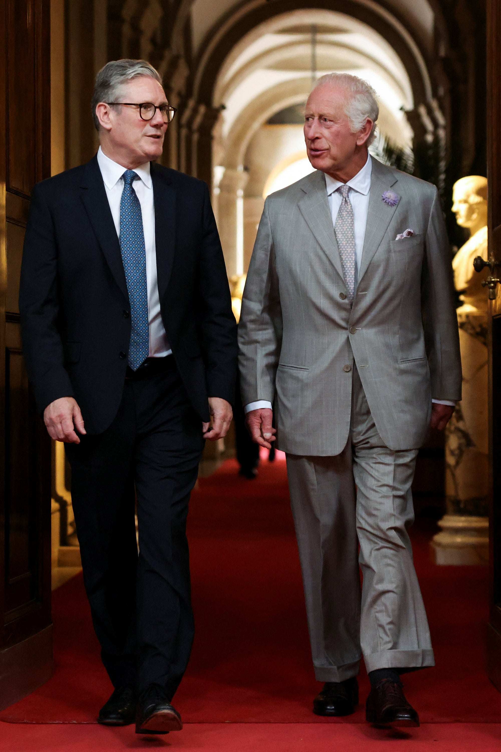 King Charles III walking with Prime Minister Sir Keir Starmer last month