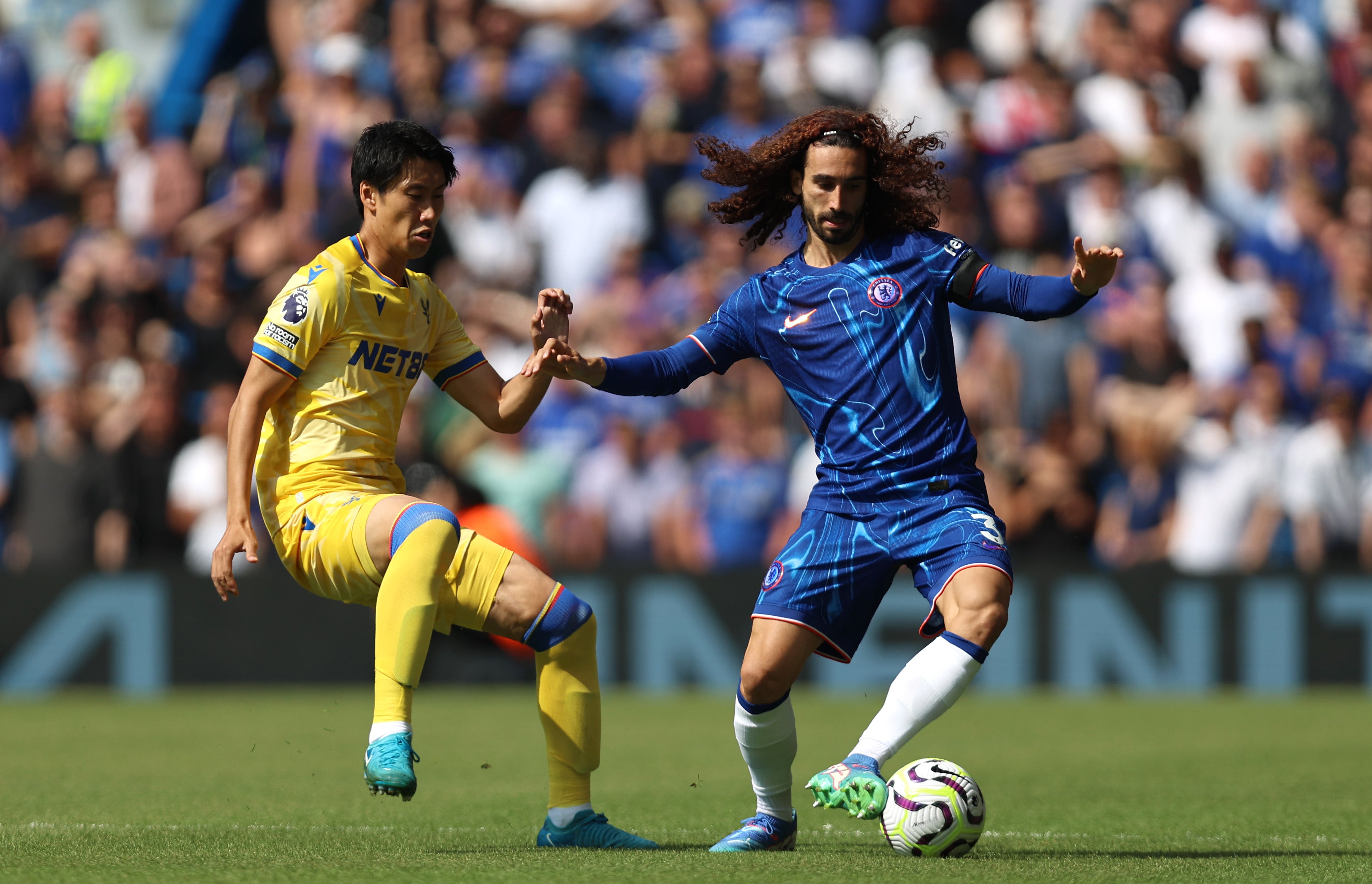 Marc Cucurella holds off Daichi Kamada