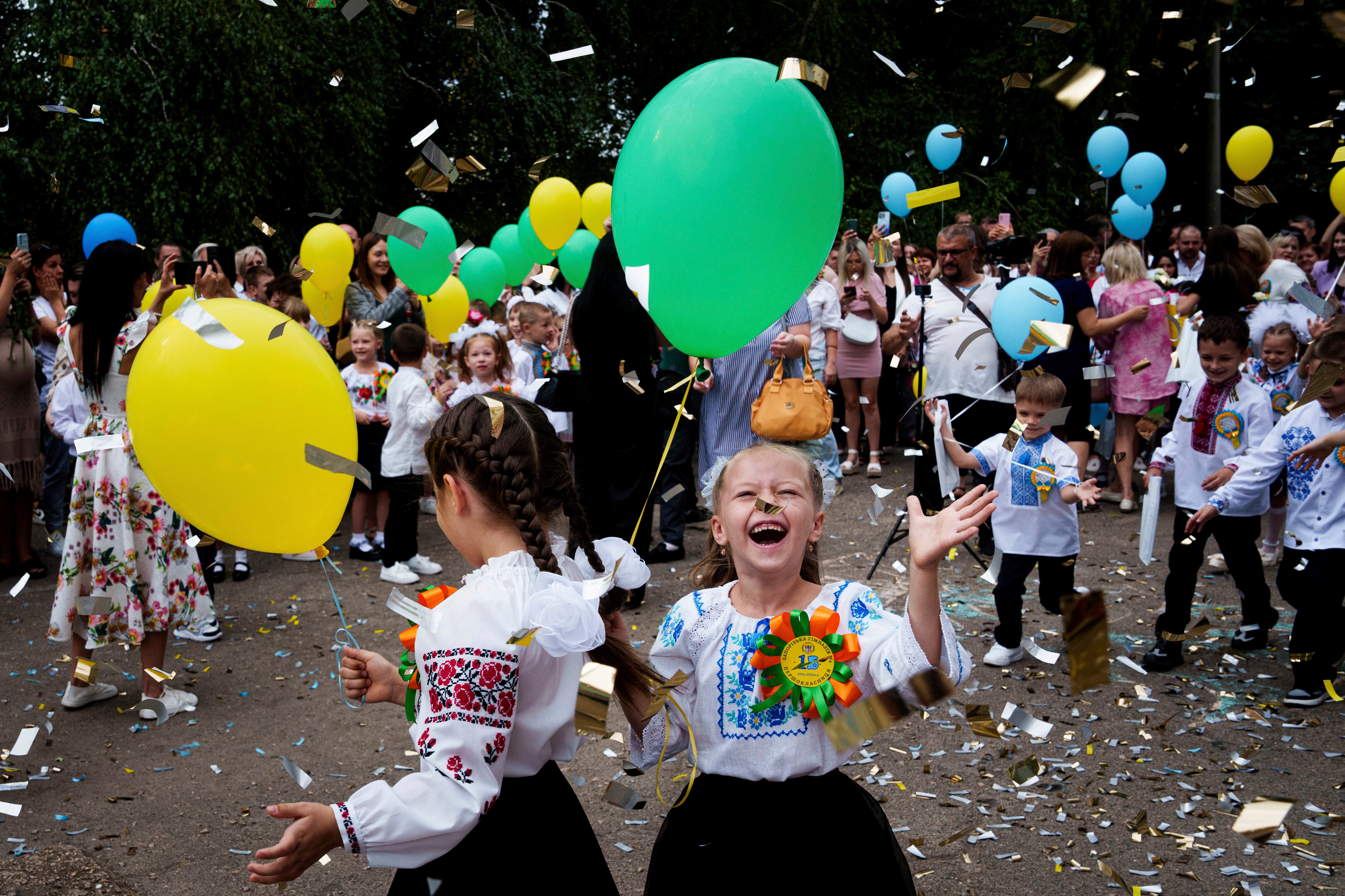 First-grades attend the traditional ceremony for the first day of school in Zaporizhzhia, Ukraine, on Sunday