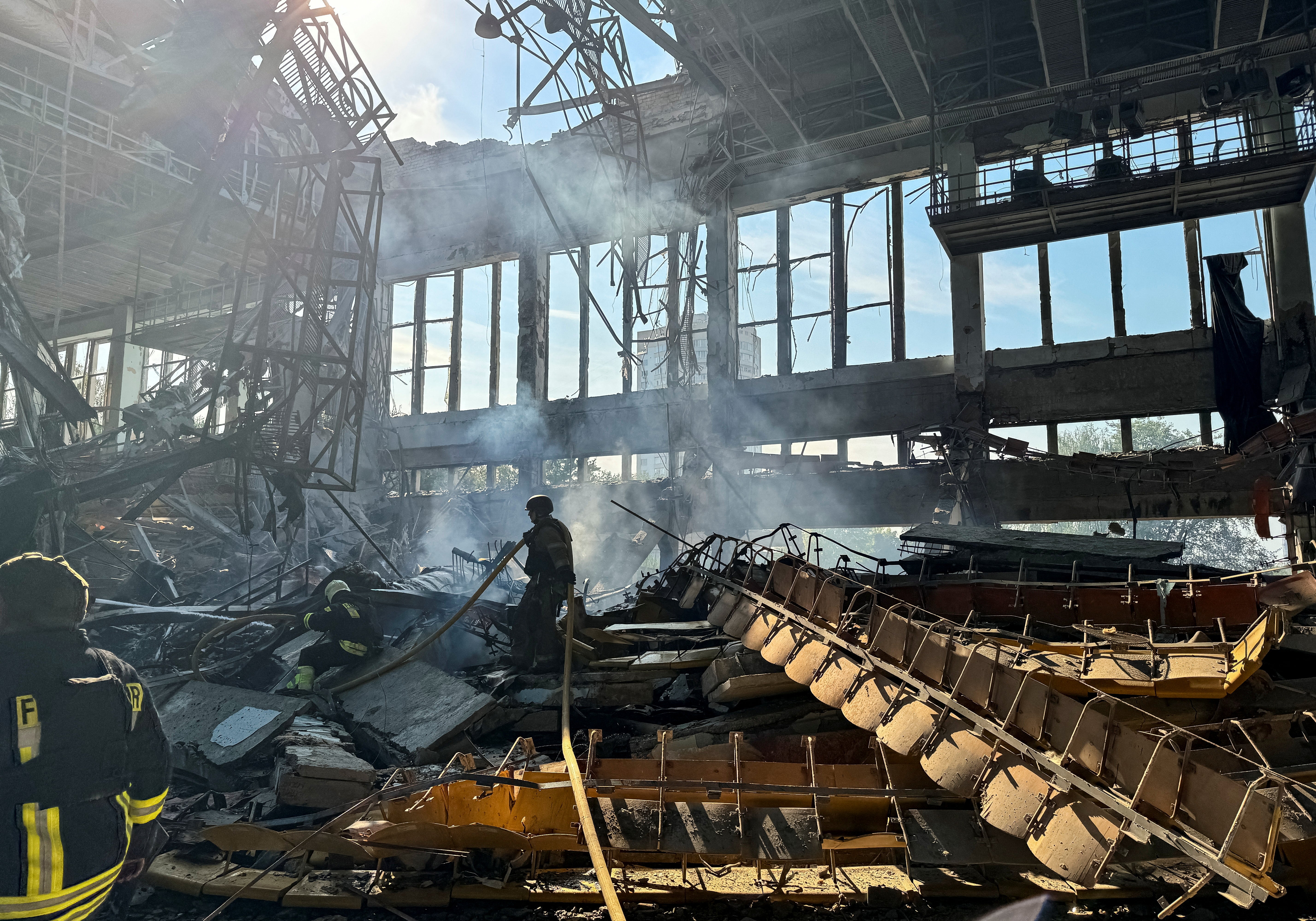 Firefighters work at the site of a Russian missile strike in Kharkiv on Sunday