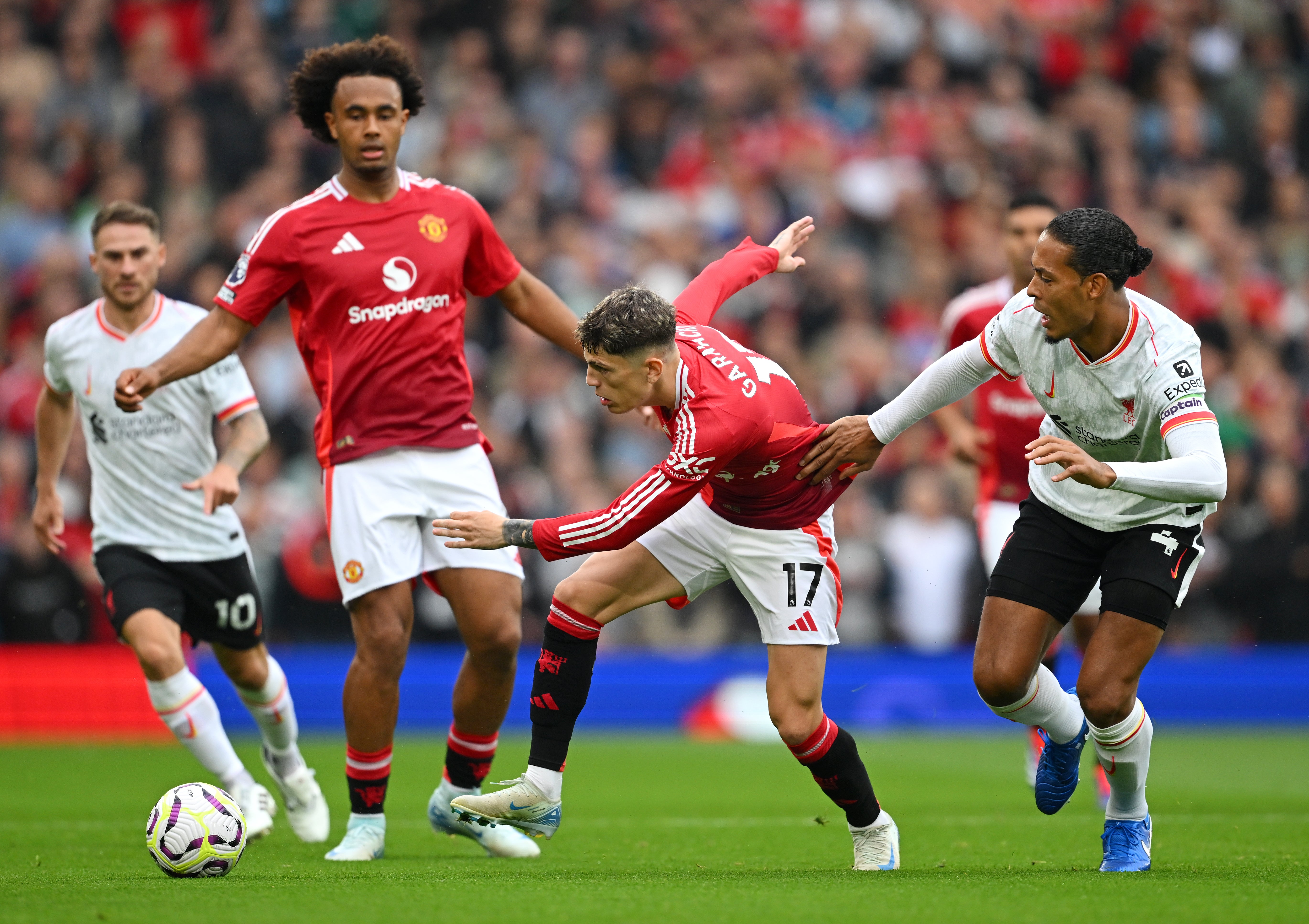 Manchester United’s Alejandro Garnacho battles with Virgil van Dijk