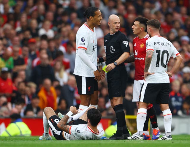 <p>Virgil van Dijk confronts Lisandro Martinez after a robust tackle</p>