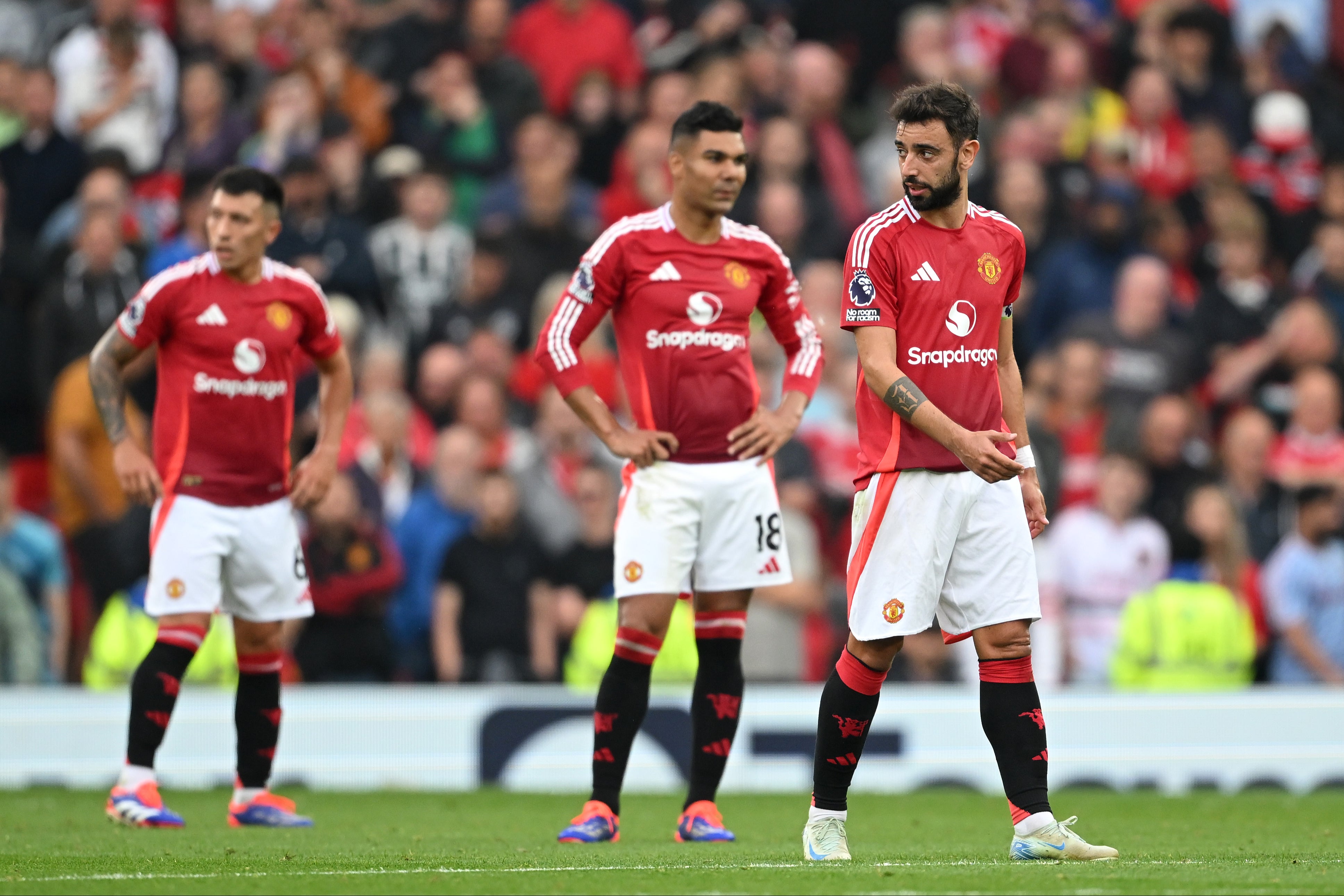 Manchester United players react during the defeat by Liverpool